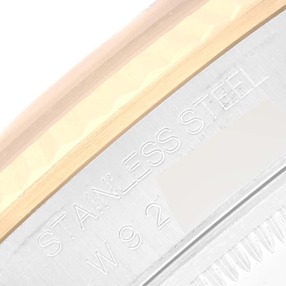 The image shows a close-up of the engraving and part of the bezel on a Rolex Datejust 16233 Men's Steel and Gold (two tone) Silver Dial 16233 Men's Steel and Gold (two tone) Silver Dial watch.