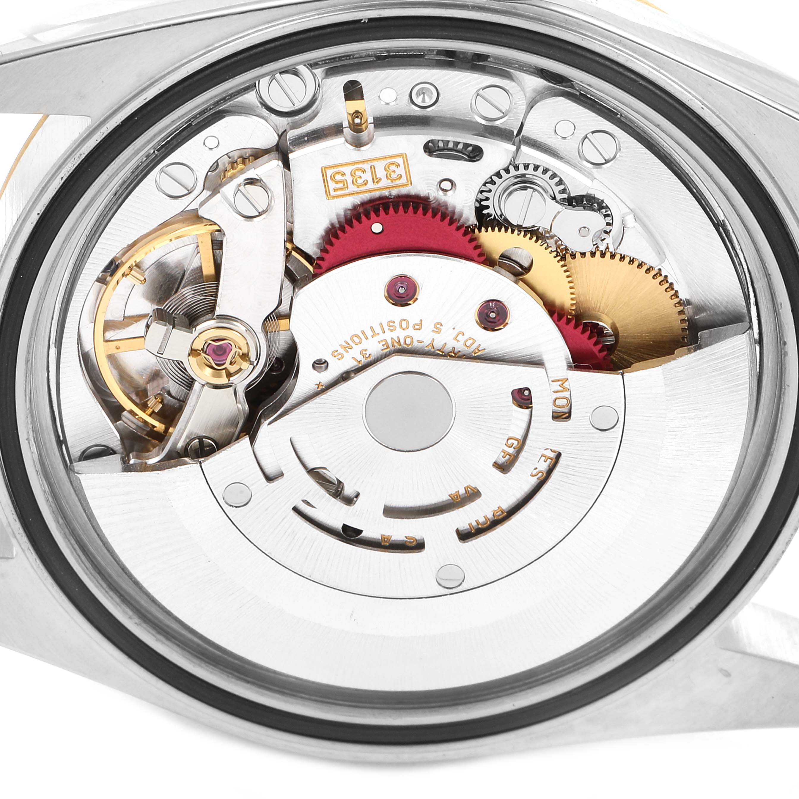 The image shows the intricate internal mechanics and movement of the Rolex Datejust 16233 Men
s Steel and Gold (two tone) Grey Dial 16233 Men
s Steel and Gold (two tone) Grey Dial watch from a close-up angle.