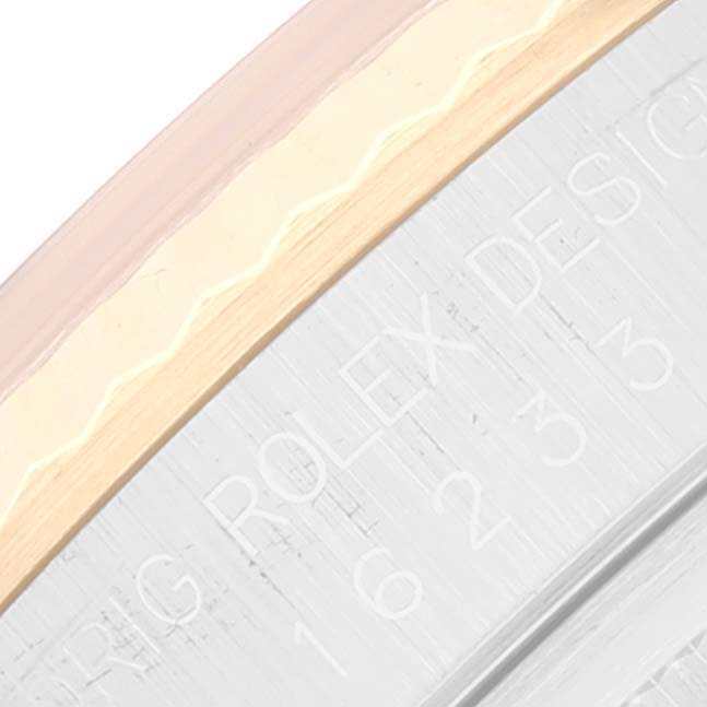 The image shows a close-up of the bezel and part of the case with engravings of a Rolex Datejust 16233 Men's Steel and Gold (two tone) White Dial 16233 Men's Steel and Gold (two tone) White Dial watch.