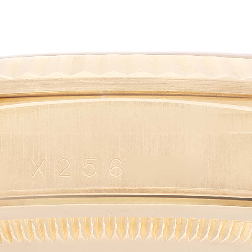 This close-up image shows the side engraving of a Rolex President 18238 Men's Yellow Gold Champagne Dial 18238 Men's Yellow Gold Champagne Dial model watch, focusing on its serial number.