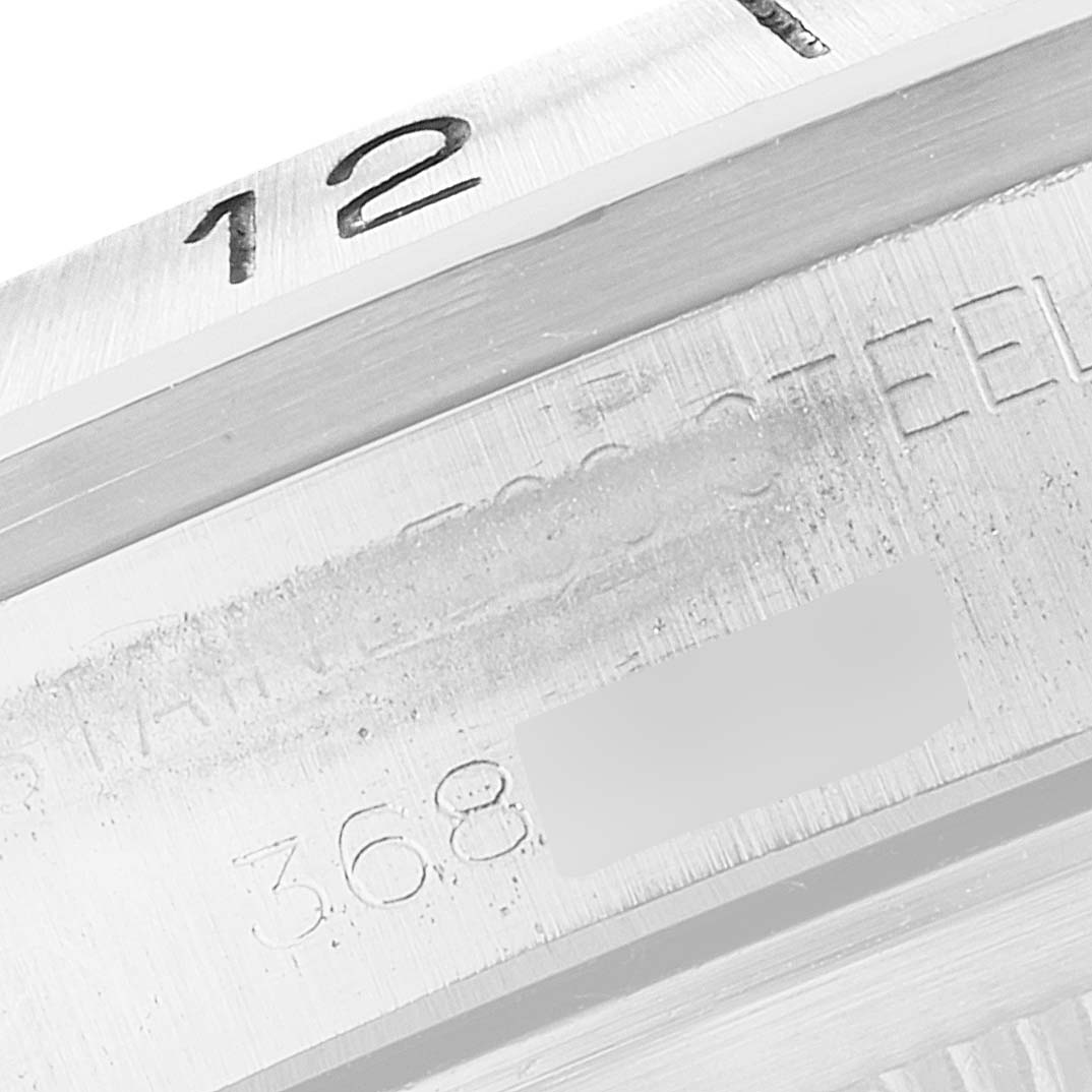 The image shows a close-up of the bezel and part of the casing with engraved numbers and text of a Vintage Collection model by Rolex.