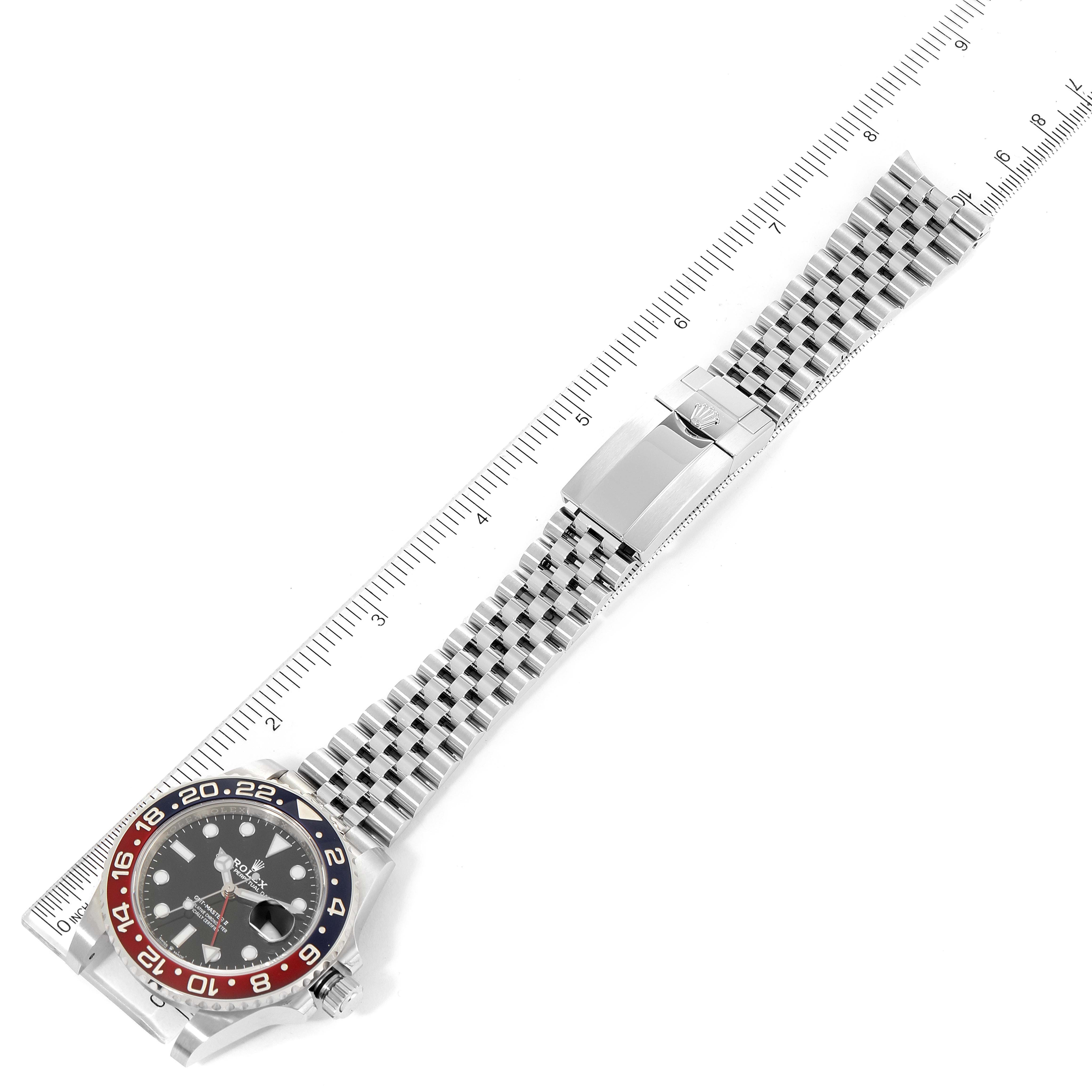 The image shows a Rolex GMT-Master 126710 Men's Stainless Steel Black Dial 126710 Men's Stainless Steel Black Dial watch laid flat alongside a ruler, featuring its bezel, dial, and bracelet.