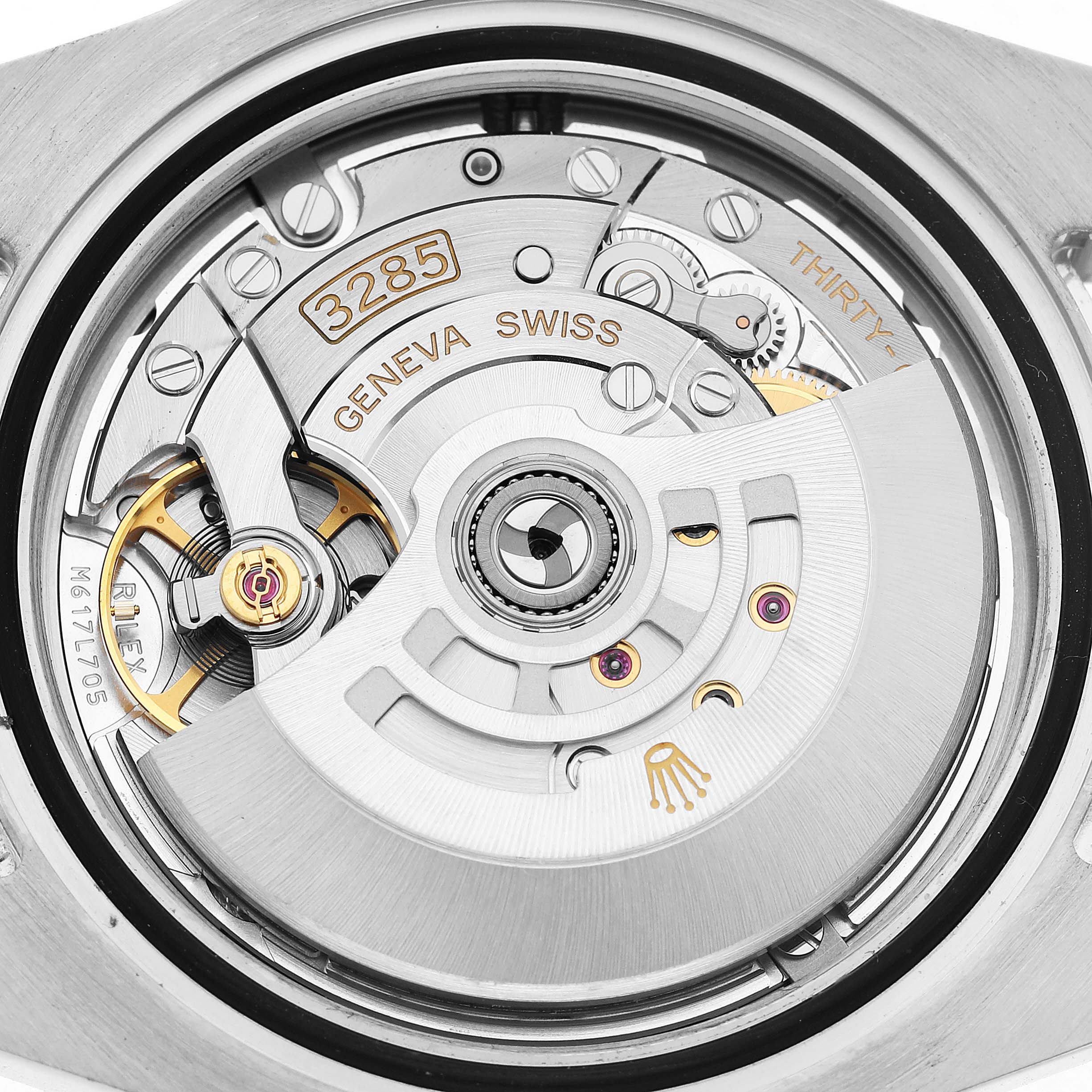 The image shows the movement of a Rolex GMT-Master 126710BLRO Men's Stainless Steel Black Dial, highlighting the rotor and intricate gear components.