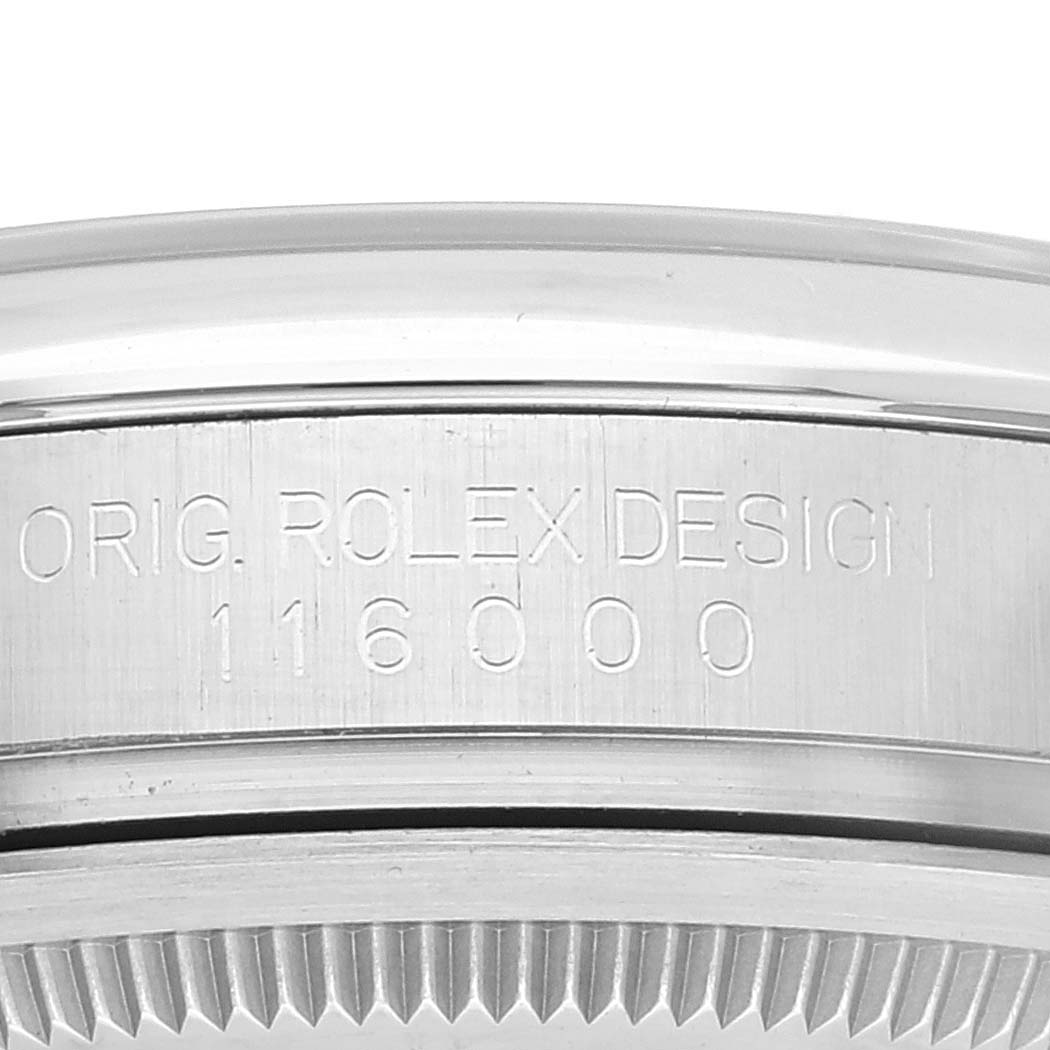 This image shows a close-up of the side engraving on the caseback of a Rolex Oyster Perpetual 116000 Men's Stainless Steel Black Dial 116000 Men's Stainless Steel Black Dial model 116000 watch.