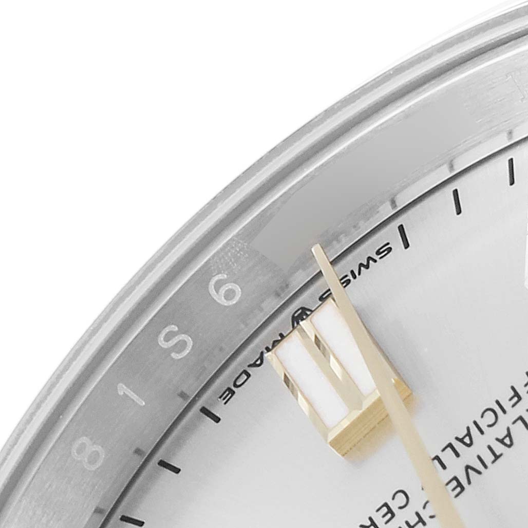This close-up image shows the dial and gold hour hand of the Rolex Oyster Perpetual 126000 Men's Stainless Steel Silver Dial 126000 Men's Stainless Steel Silver Dial watch.