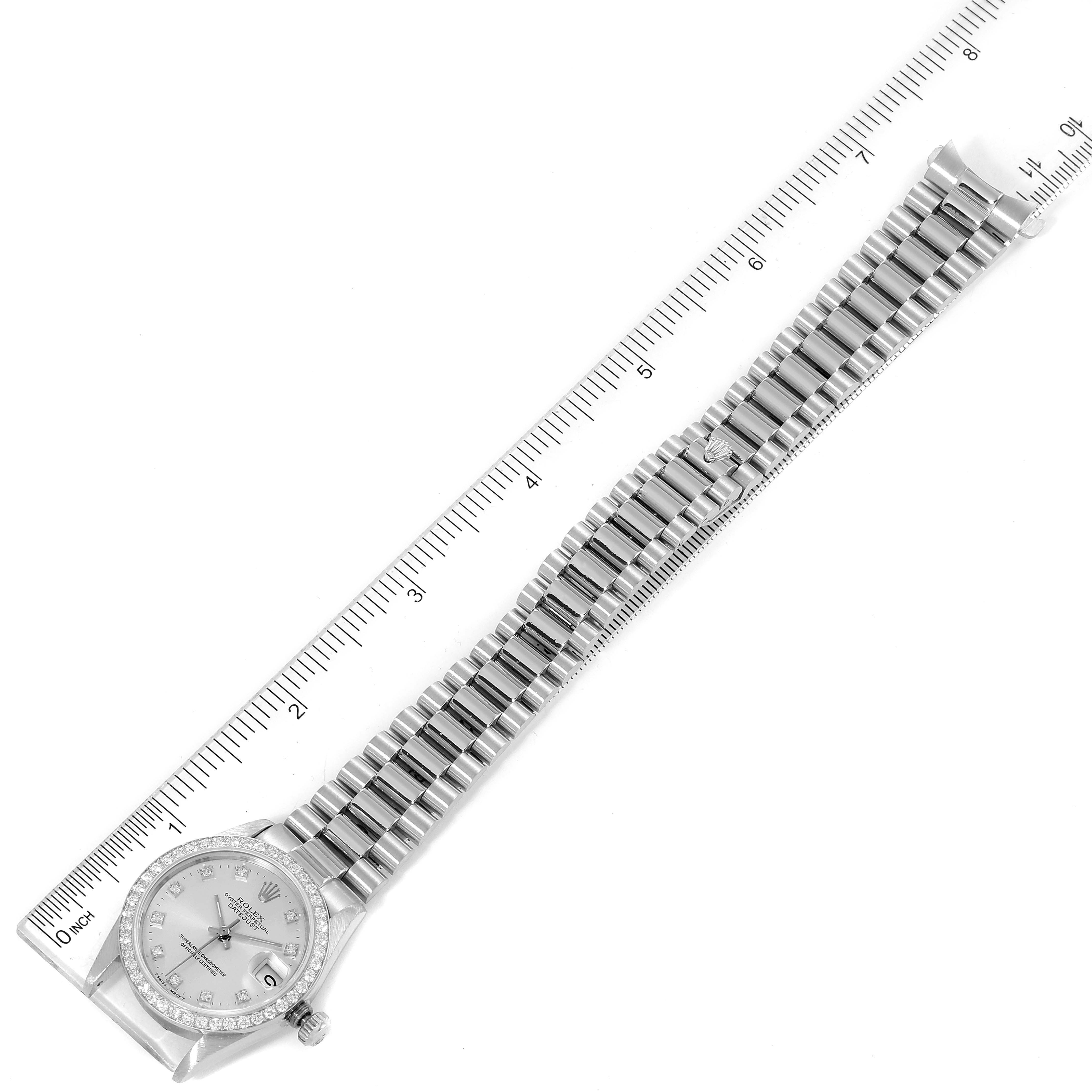 This image shows an aerial view of a Rolex President 68286 Women's Platinum Silver Dial 68286 Women's Platinum Silver Dial model watch with a ruler measuring its length.