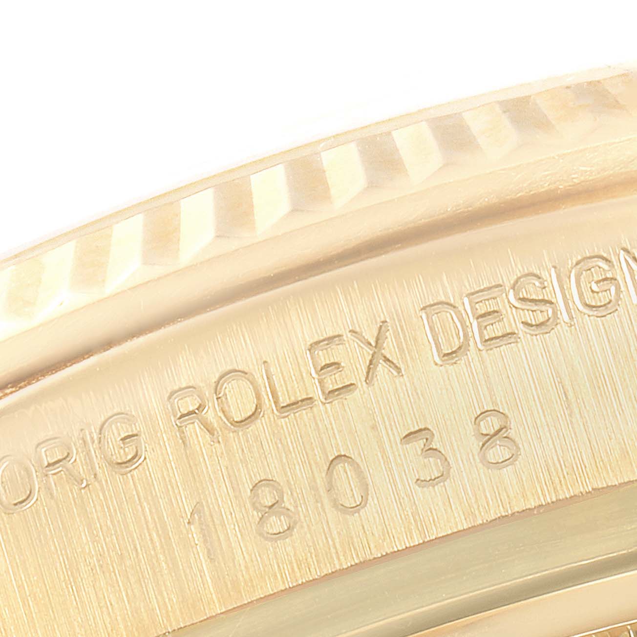 This close-up image shows the engraved case side of a Rolex President 18038 Men's Yellow Gold Champagne Dial 18038 Men's Yellow Gold Champagne Dial model watch.