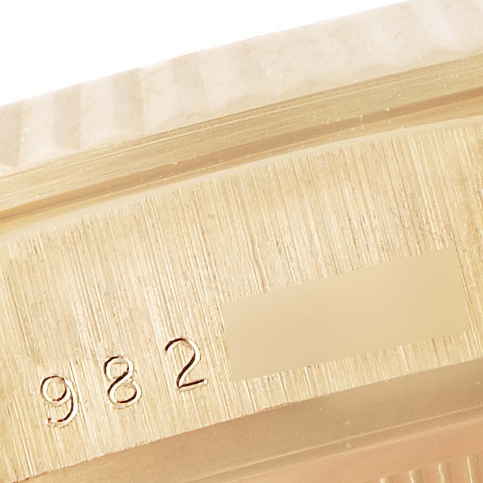 This close-up image features the serial number and part of the bezel on a Rolex President 18038 Men's Yellow Gold Champagne Dial 18038 Men's Yellow Gold Champagne Dial watch.