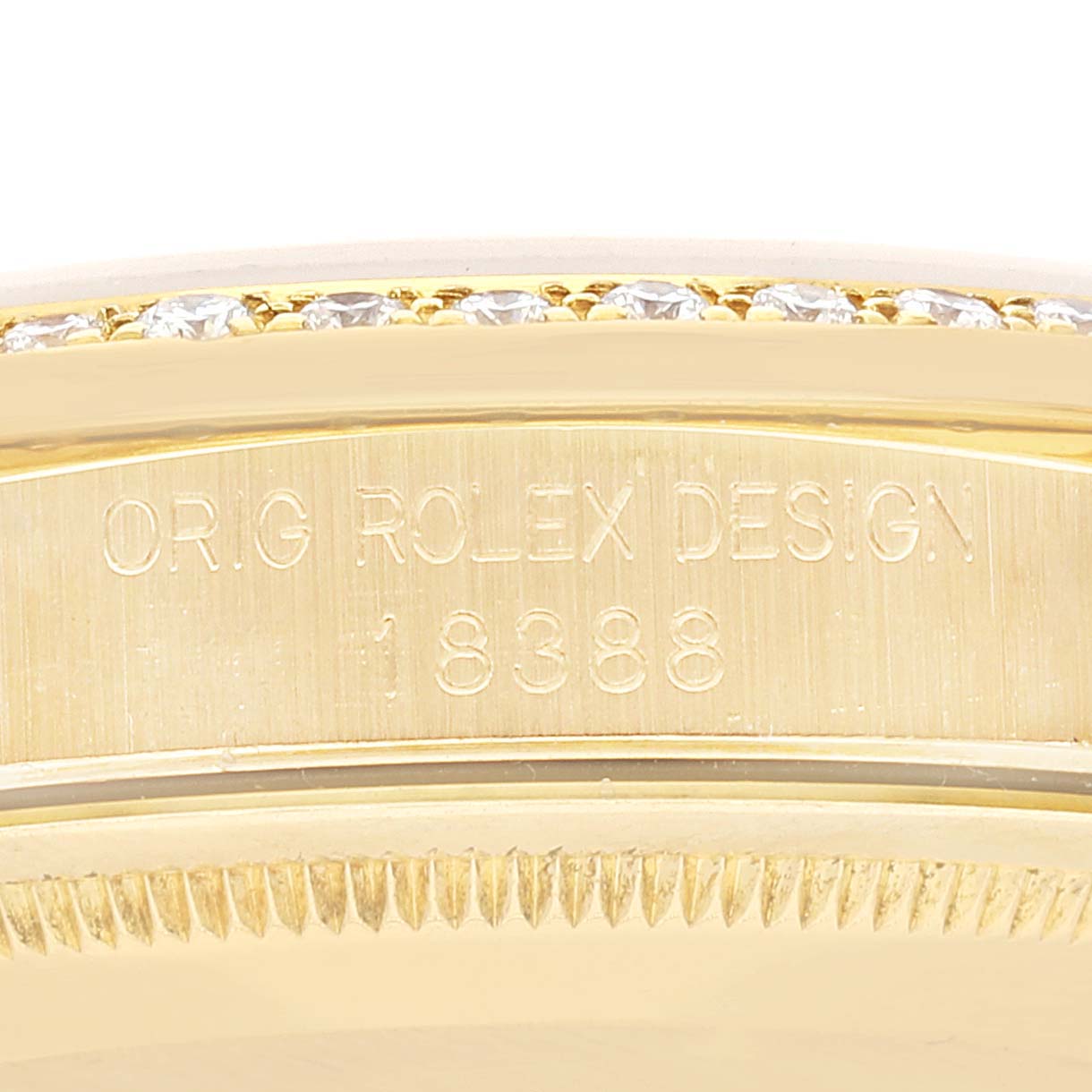 This image shows a close-up of the case and serial number of a Rolex President 18388 Men
s Yellow Gold Champagne Dial 18388 Men
s Yellow Gold Champagne Dial model, featuring the engraved design and diamond bezel.