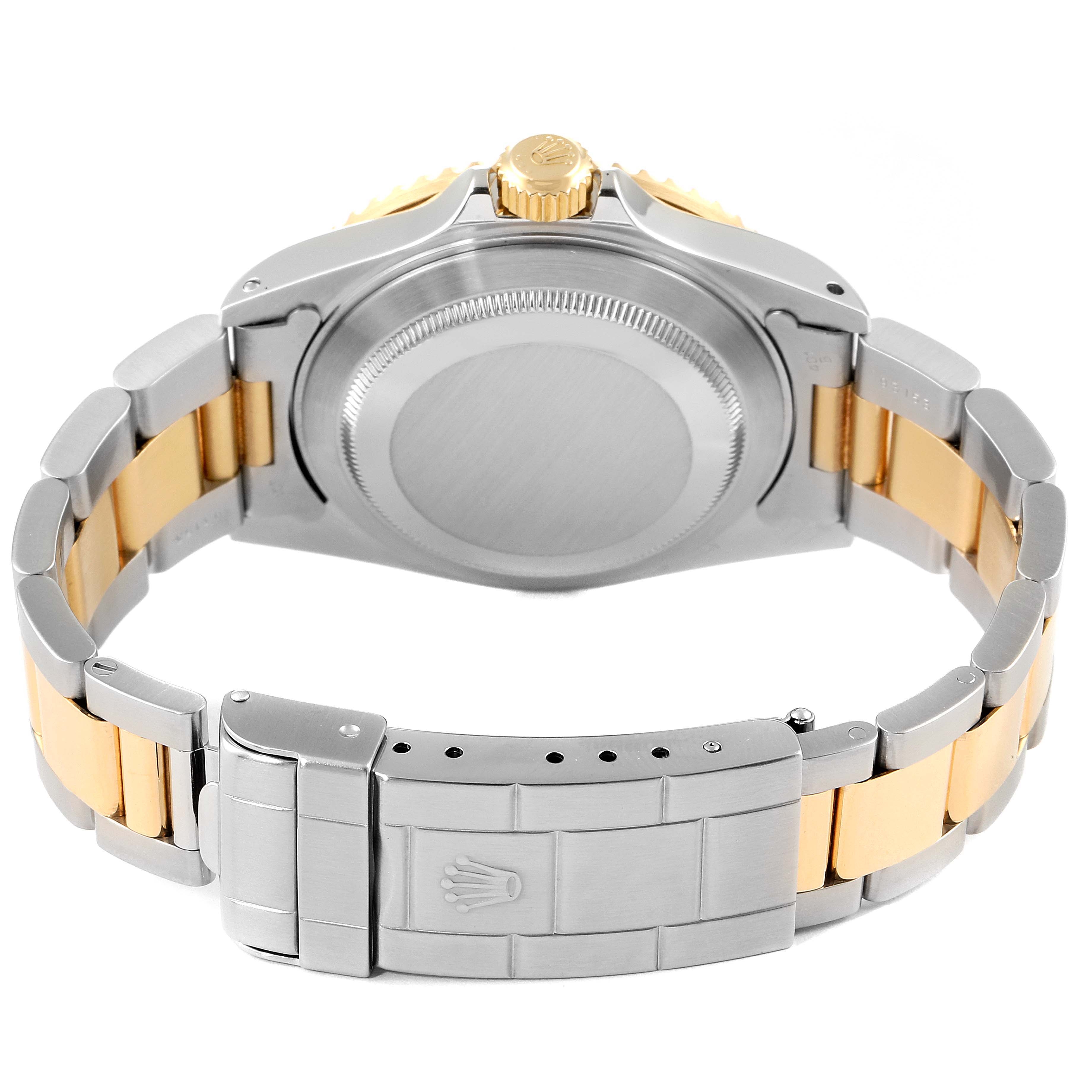 This image shows the back casing and bracelet of a Rolex Submariner 16613 Men's Steel and Gold (two tone) Blue Dial 16613 Men's Steel and Gold (two tone) Blue Dial watch, with a two-tone metal design.