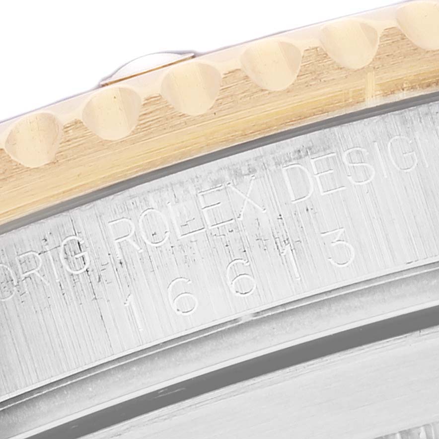 This close-up image shows the bezel and side engraving of a Rolex Submariner 16613 Men's Steel and Gold (two tone) Blue Dial 16613 Men's Steel and Gold (two tone) Blue Dial watch, revealing part of its model number.