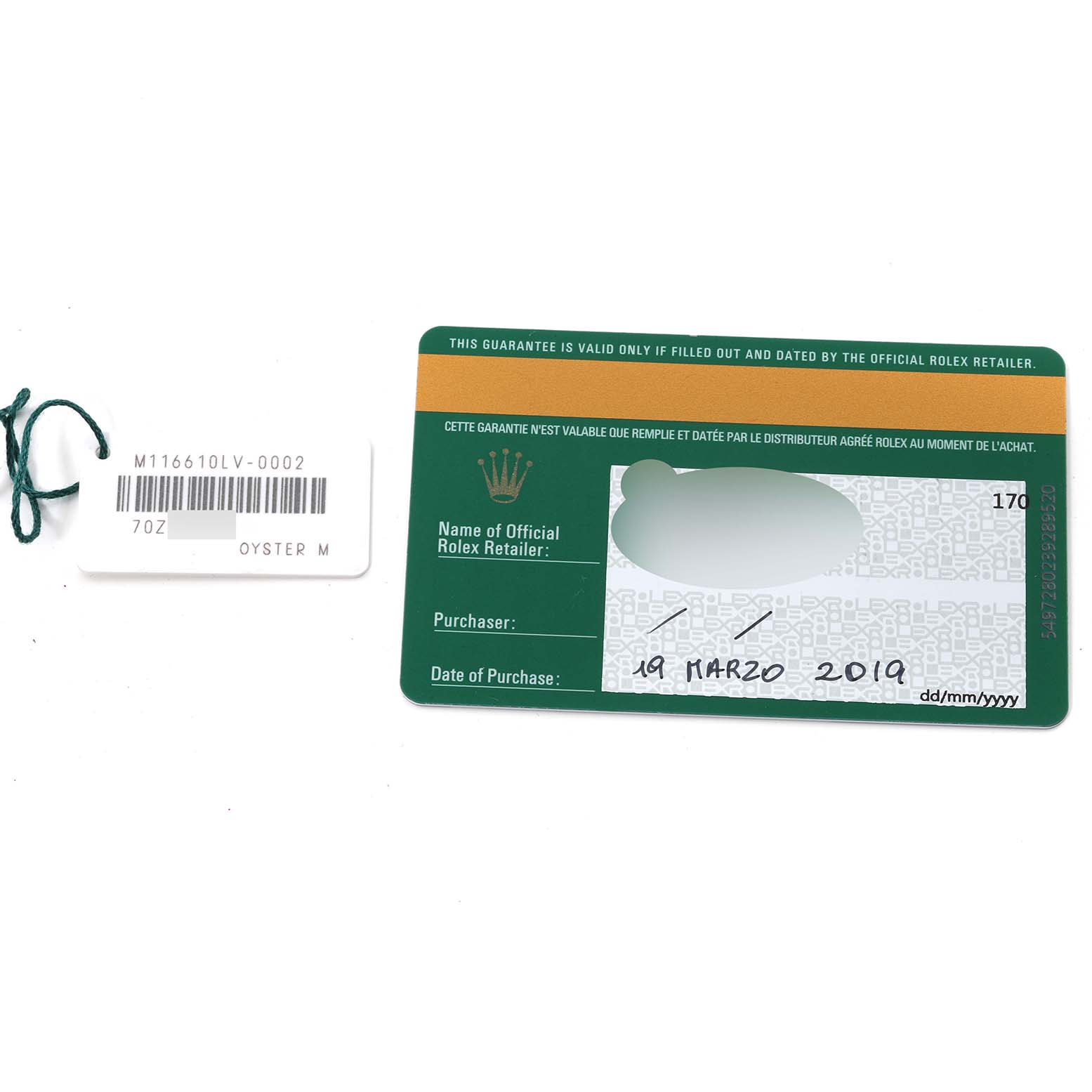 The image shows a warranty card and a tag for a Rolex Submariner 116610LV Men
s Stainless Steel Green Dial 116610LV Men
s Stainless Steel Green Dial model, photographed from above.