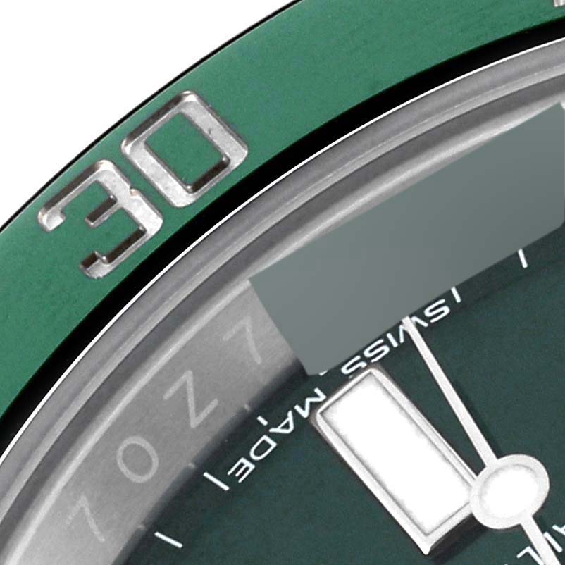 The image shows a close-up of the dial and bezel of a Rolex Submariner 116610LV Men
s Stainless Steel Green Dial 116610LV Men
s Stainless Steel Green Dial, focusing on the "30" mark and part of the minute hand.
