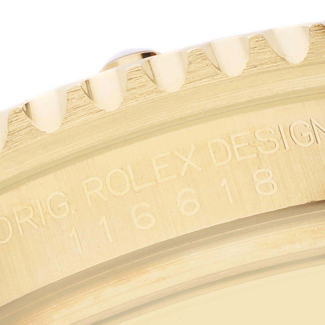 This close-up image shows the engraved edge and bezel of a Rolex Submariner 116618 Men's Yellow Gold Blue Dial 116618 Men's Yellow Gold Blue Dial watch.