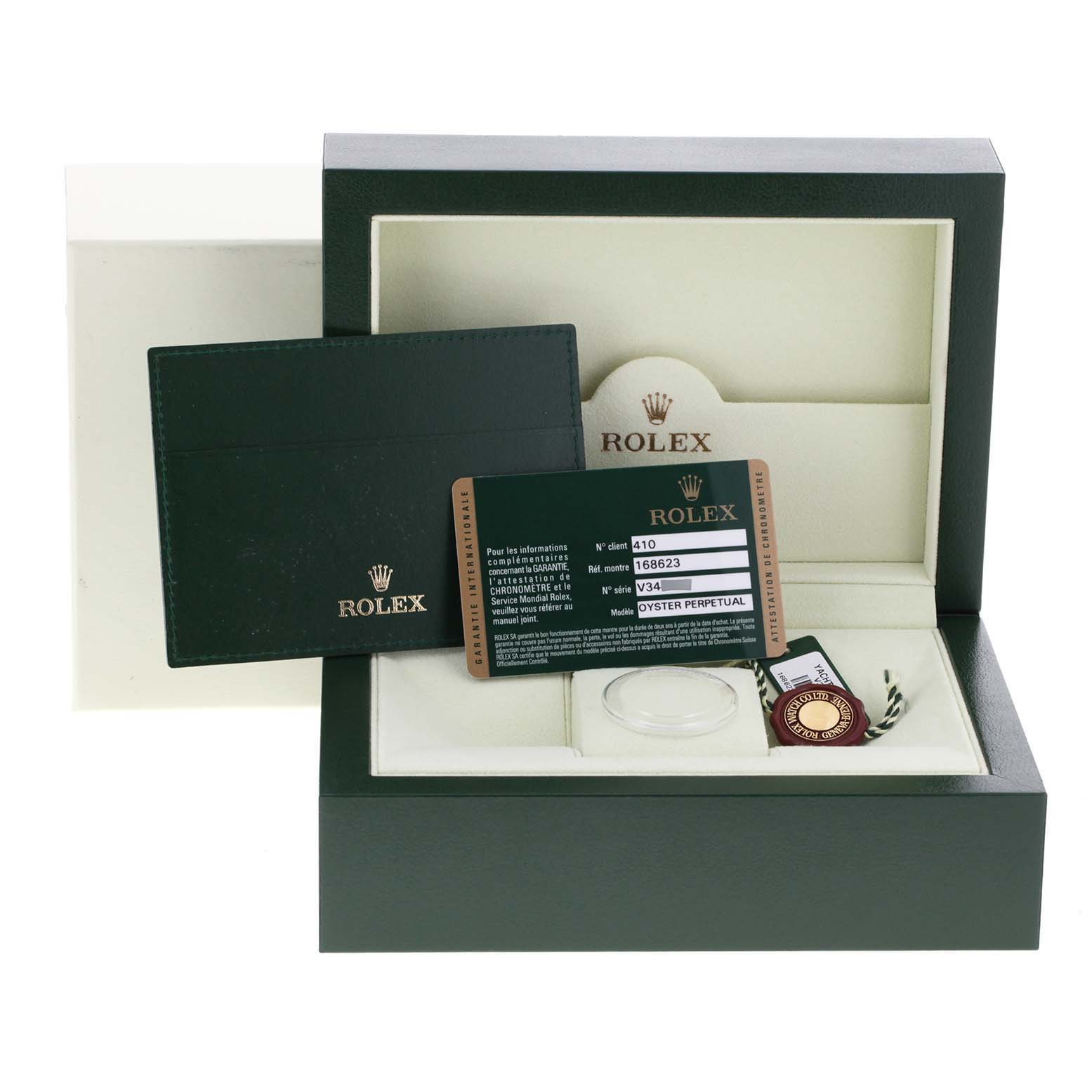 The image shows the Rolex Yacht-Master 168623 Men
s Steel and Gold (two tone) White Dial 168623 Men
s Steel and Gold (two tone) White Dial watch box, warranty card, and other accessories from a frontal angle.