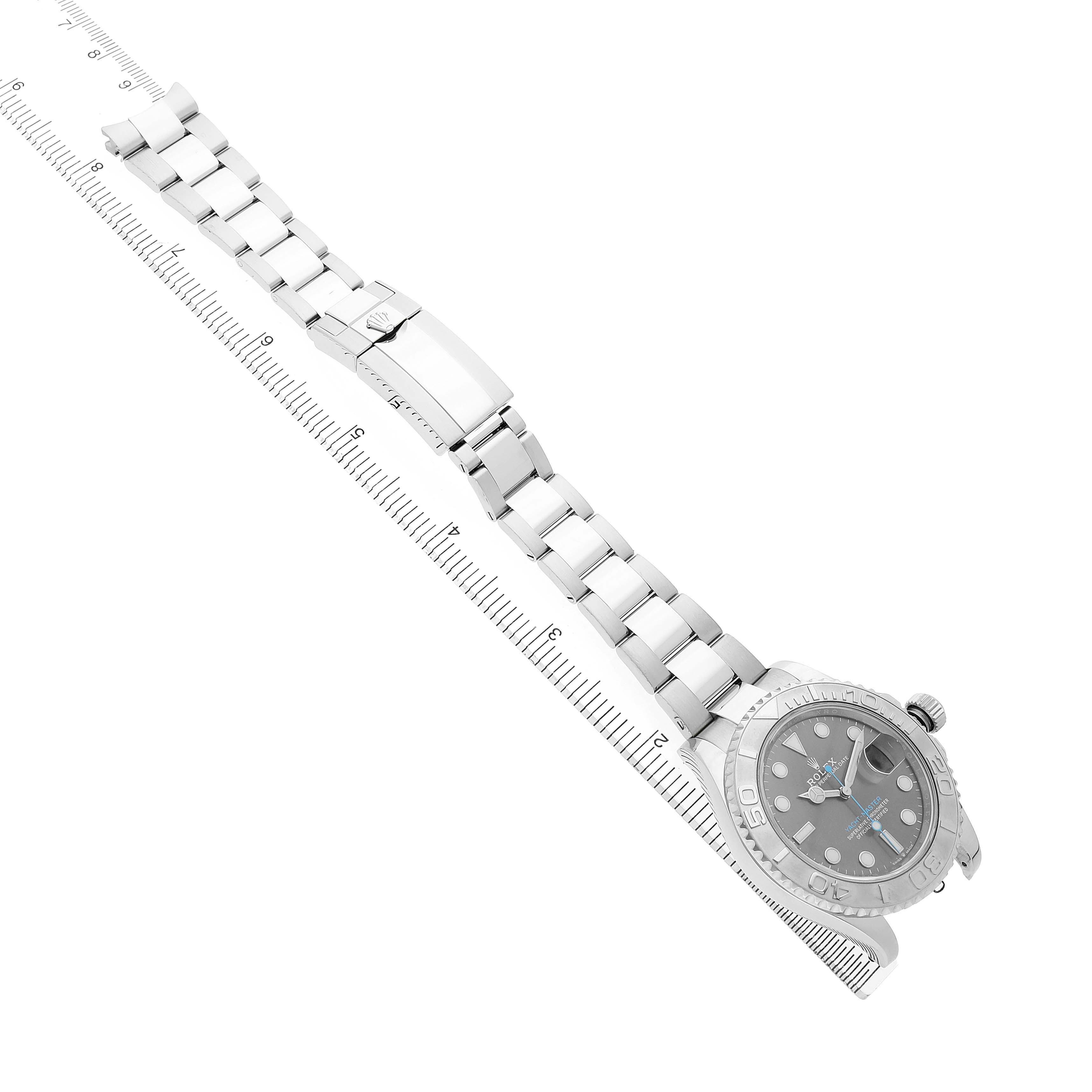 The Rolex Yacht-Master M126622-0001 Men's Stainless Steel Grey Dial is shown from an angled top-down view displaying the dial, bracelet, and clasp alongside a ruler.