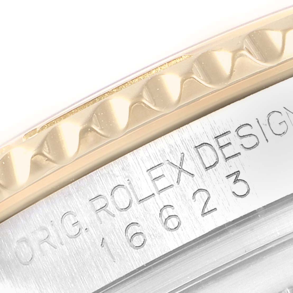 The image shows a close-up of the edge and engravings on a Rolex Yacht-Master 16623 Men
s Steel and Gold (two tone) White Dial 16623 Men
s Steel and Gold (two tone) White Dial watch case.
