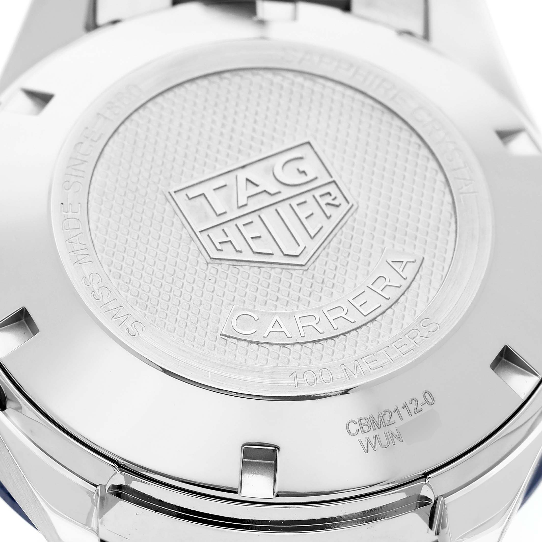 The image shows the back case of a Tag Heuer Carrera CBM2112.BA0651 Men's Stainless Steel Blue Dial watch, featuring its logo and model details.