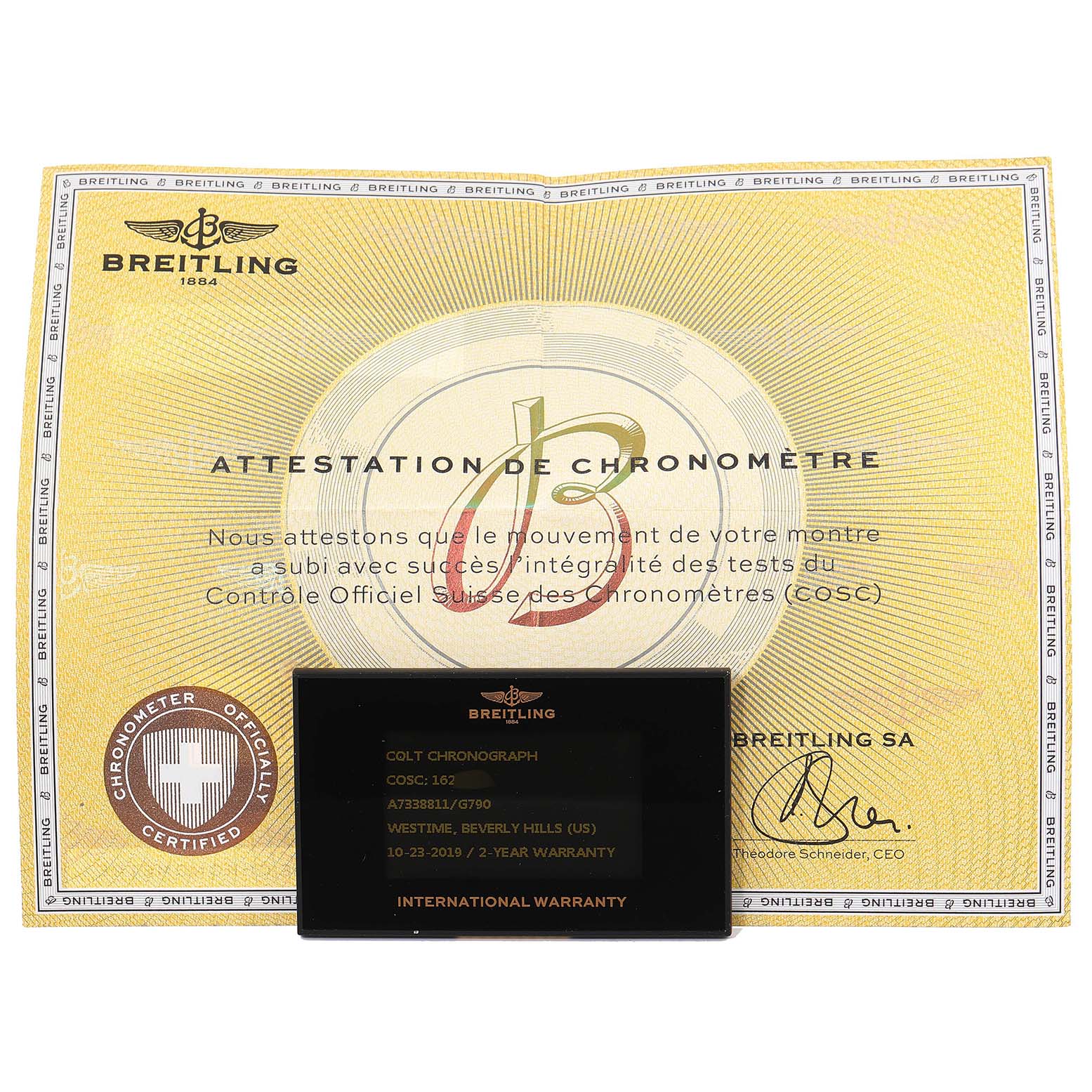 The image shows a Breitling Colt A73388 Men
s Stainless Steel White Dial A73388 Men
s Stainless Steel White Dial model
s chronometer certificate and international warranty card displayed flat.