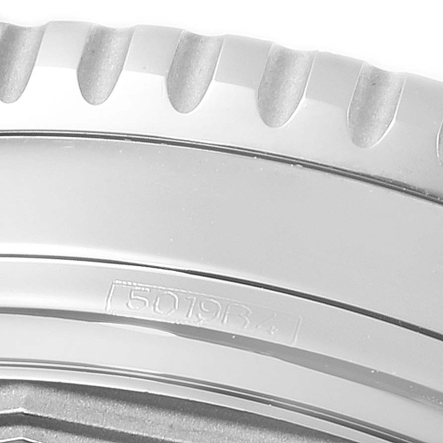 The image shows a close-up of the bezel and part of the case back of a Breitling Navitimer A13324 Men
s Stainless Steel Blue Dial A13324 Men
s Stainless Steel Blue Dial watch.