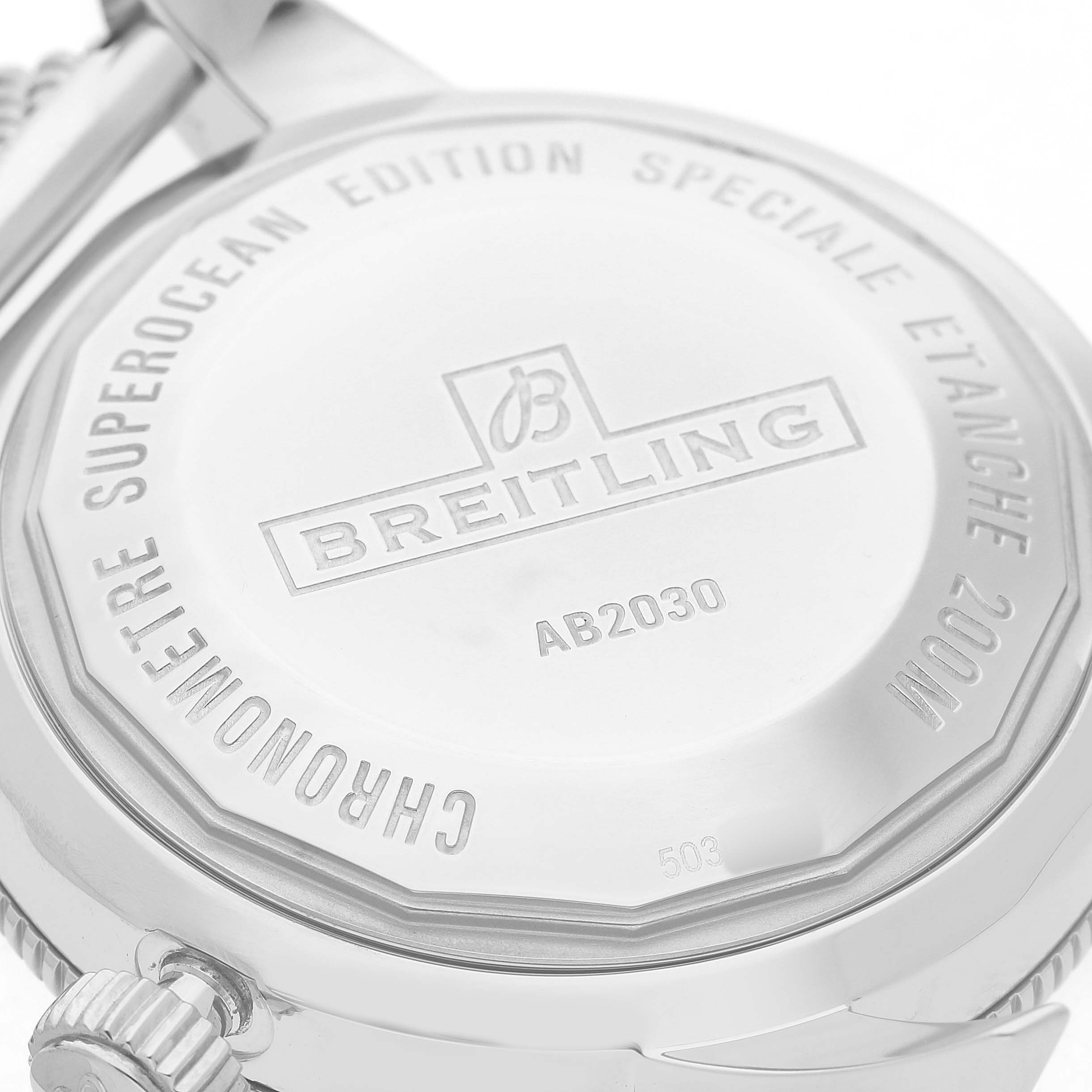 The image shows the back casing of a Breitling Superocean AB2030 Men's Stainless Steel Black Dial watch, highlighting the engraved details and brand logo.