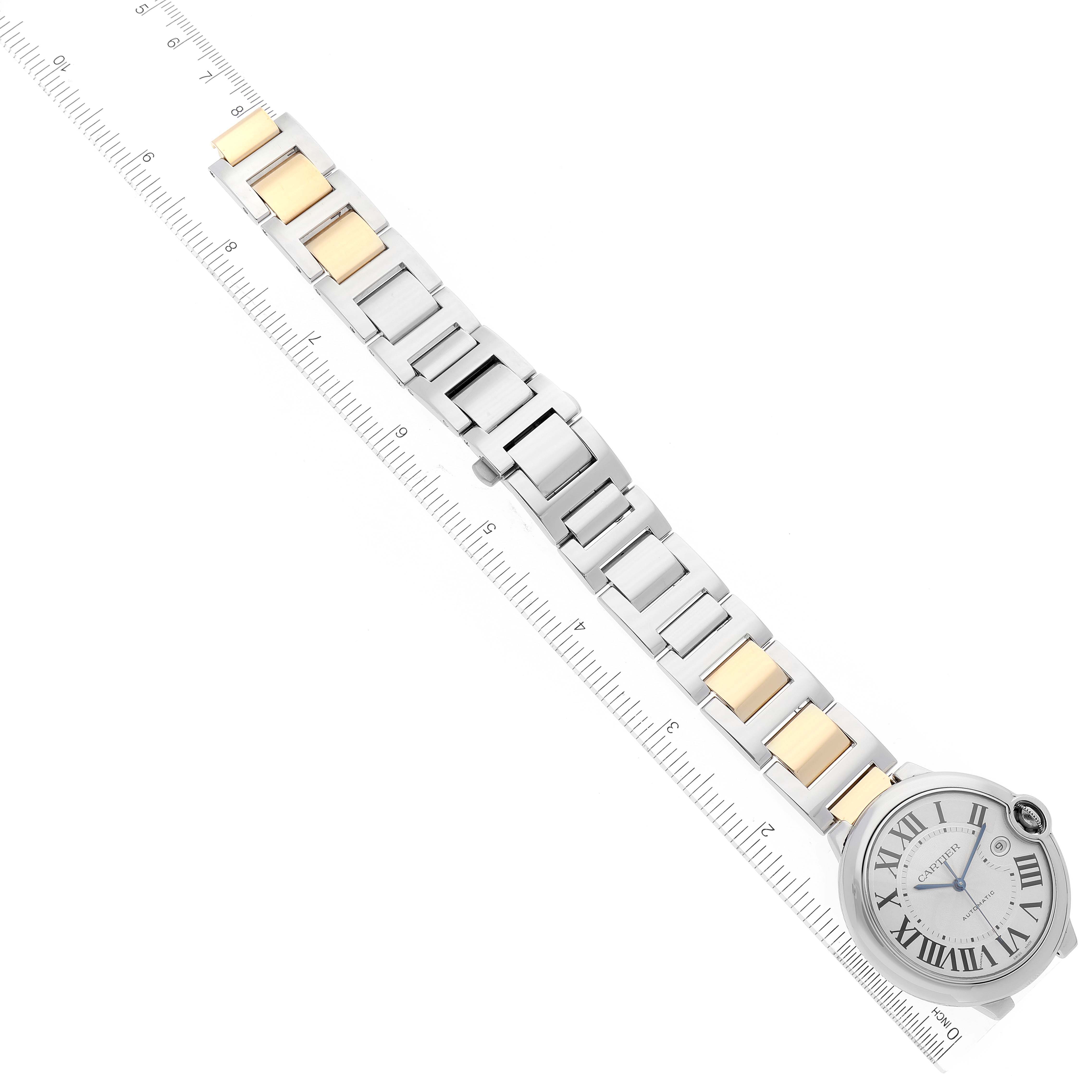 The image shows a Cartier Ballon Bleu W69009Z3 Men's Steel and Gold (two tone) Silver Dial W69009Z3 Men's Steel and Gold (two tone) Silver Dial watch from a top-down angle, displaying the watch face, bracelet, and ruler.