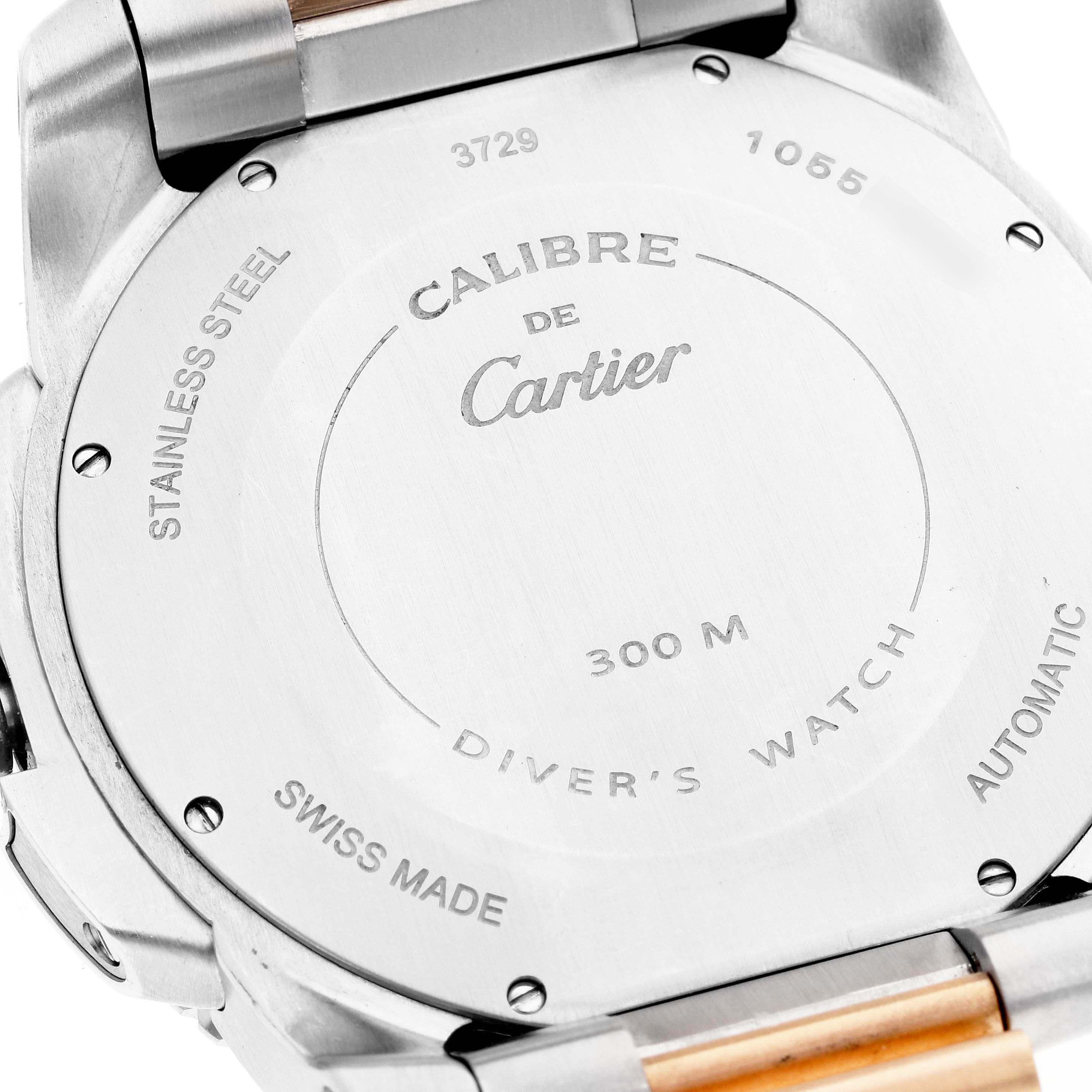 The image shows the back case of the Calibre de Cartier model by Cartier, including its markings and part of the watch band.