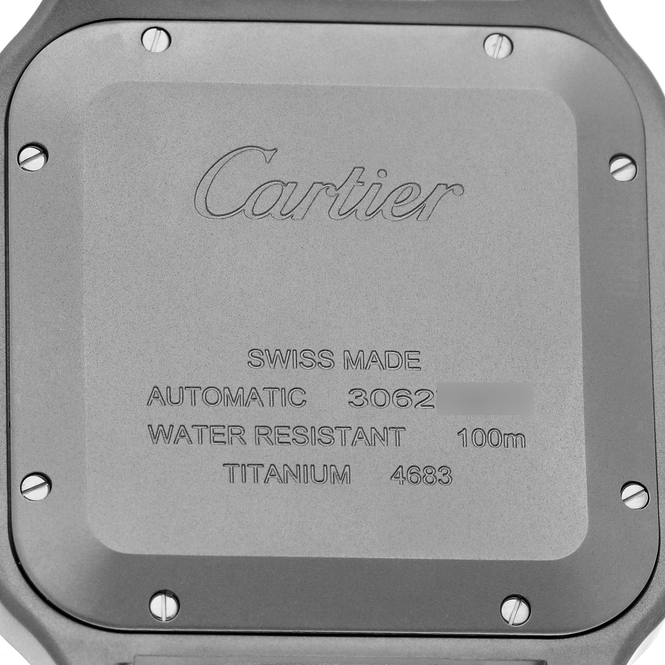The image shows the back case of a Cartier Santos WSSA0089 Men's Titanium Silver Dial watch, featuring engraved details about its specifications.