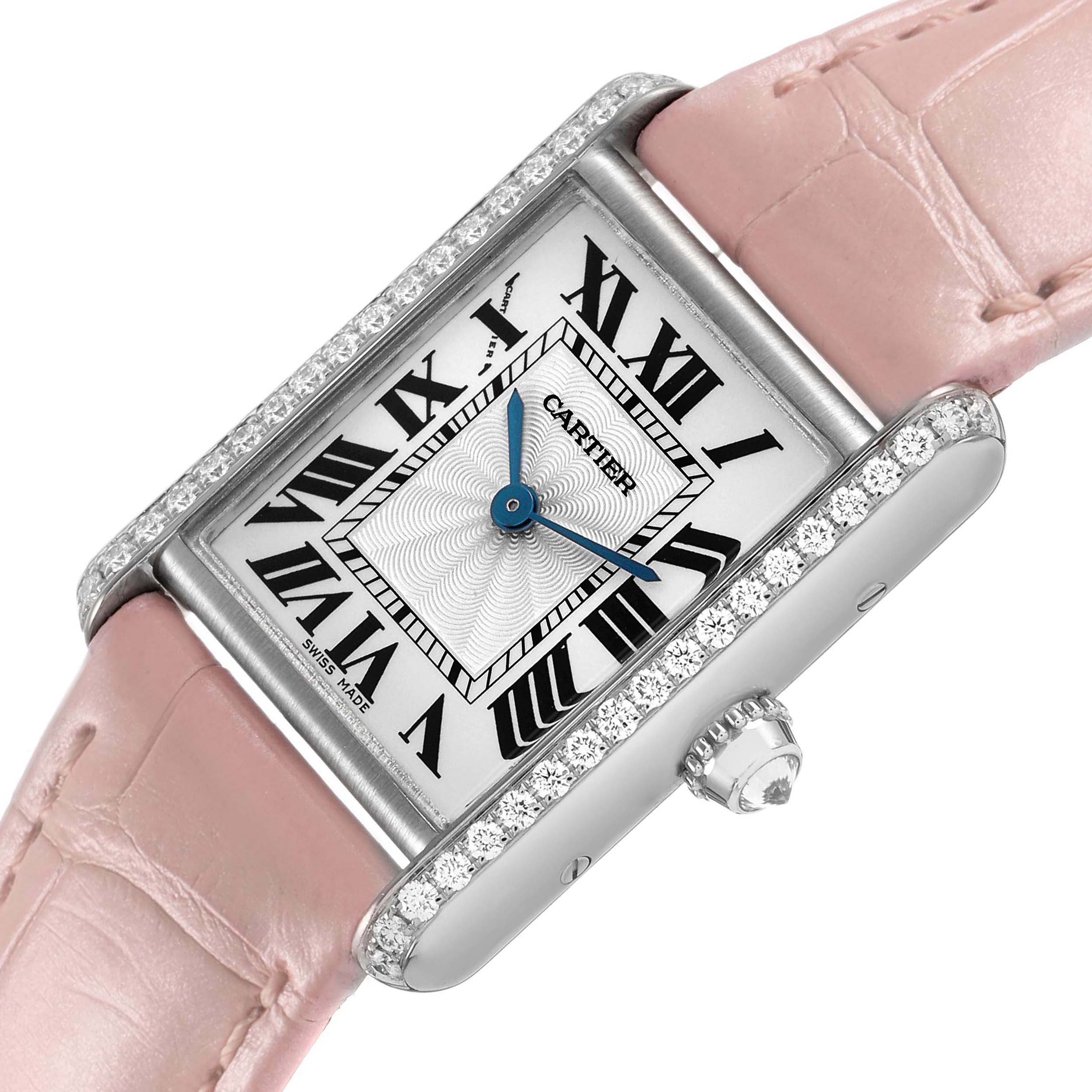 The Cartier Tank Louis WJTA0011 Women's White Gold Silver Dial watch is shown at an angle highlighting the face, Roman numerals, pink strap, and diamond bezel.