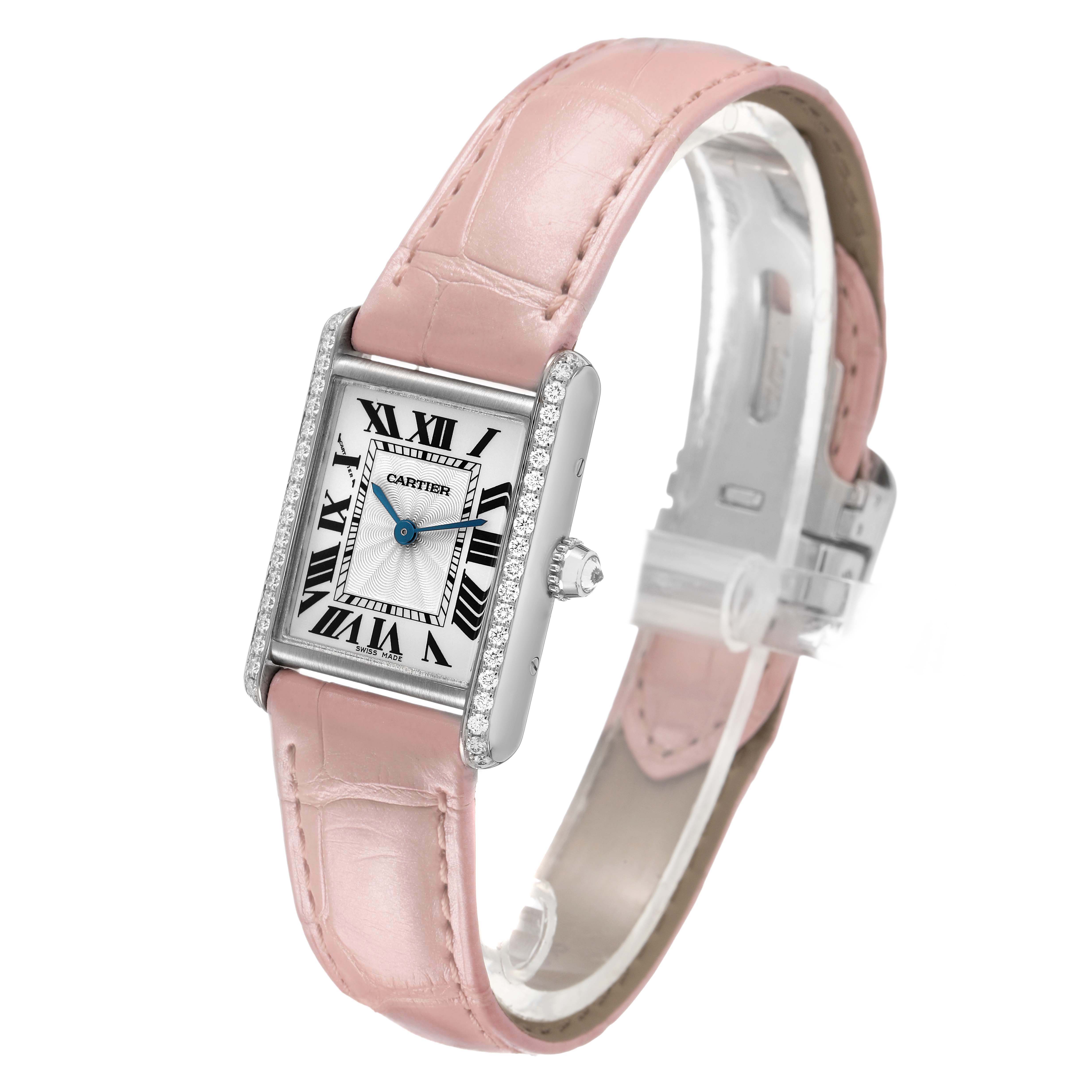 The Cartier Tank Louis WJTA0011 Women's White Gold Silver Dial watch is shown at a three-quarter angle, highlighting its pink strap, diamond bezel, and rectangular face.
