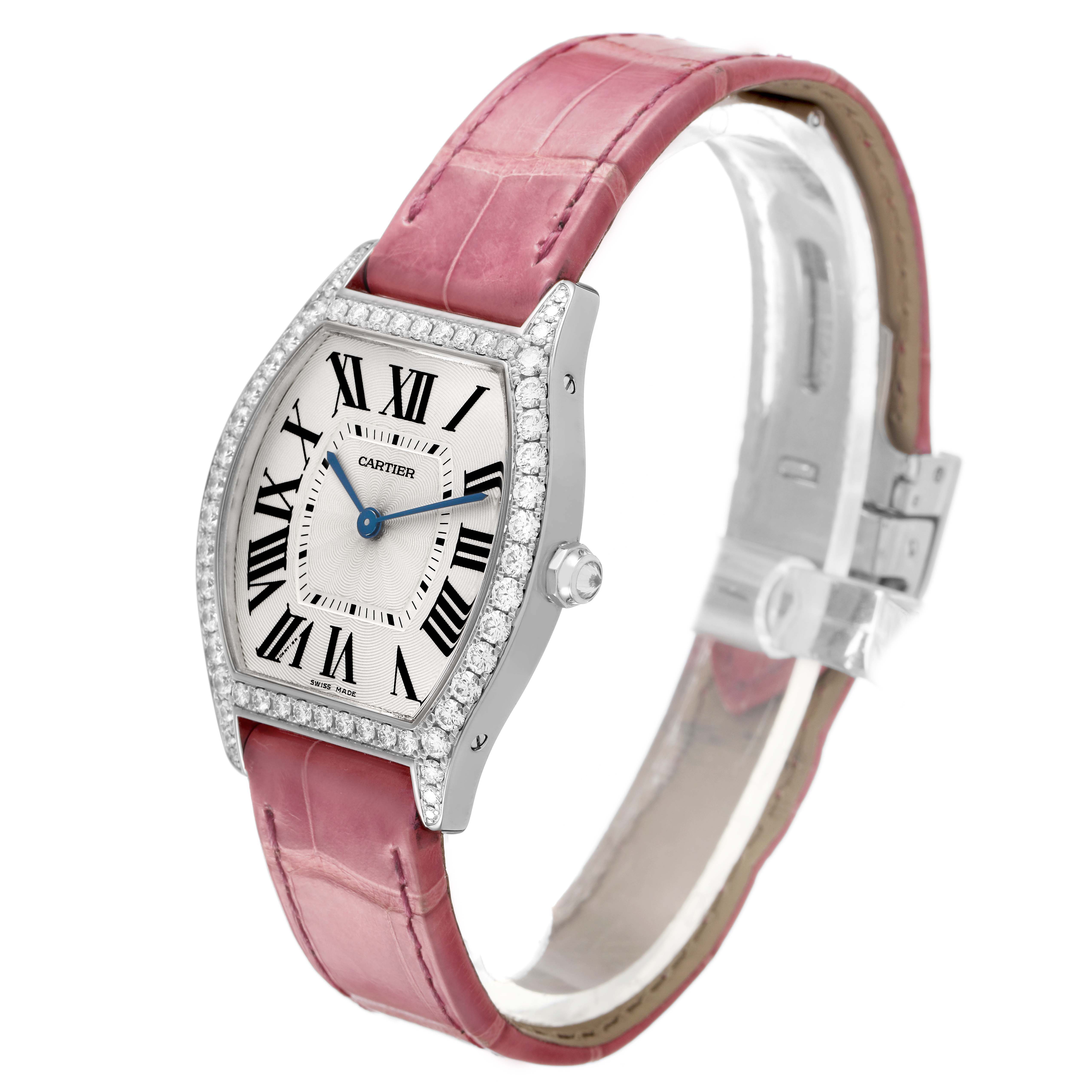 The Cartier Tortue WA501009 Women's White Gold Silver Dial watch is shown at a slight angle, highlighting its pink strap, diamond-set case, and Roman numeral dial.