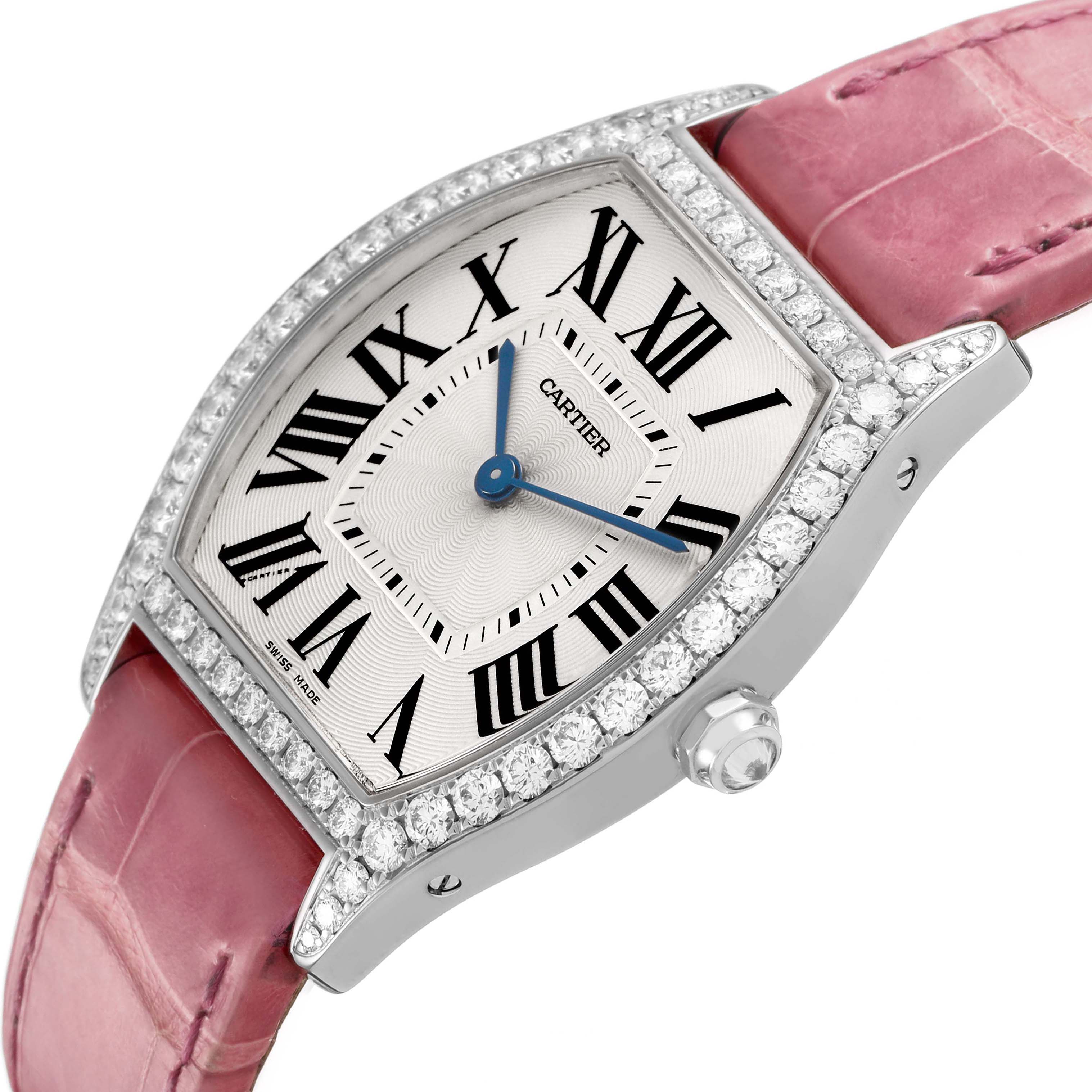 The Cartier Tortue WA501009 Women's White Gold Silver Dial watch is shown at an angled side view, highlighting its diamond-encrusted case and pink strap.