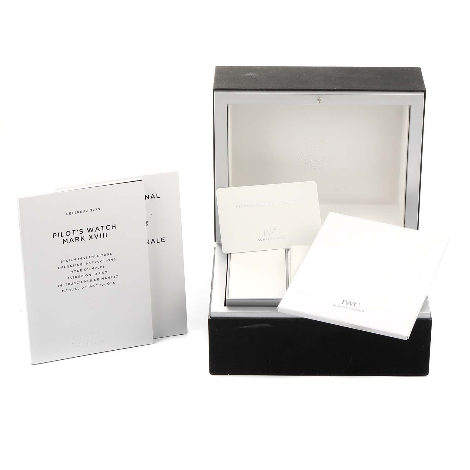 This image shows the packaging, manuals, and warranty cards for the IWC Pilot IW327007 Men's Stainless Steel Black Dial IW327007 Men's Stainless Steel Black Dial's Watch Mark XVIII from a front angle.