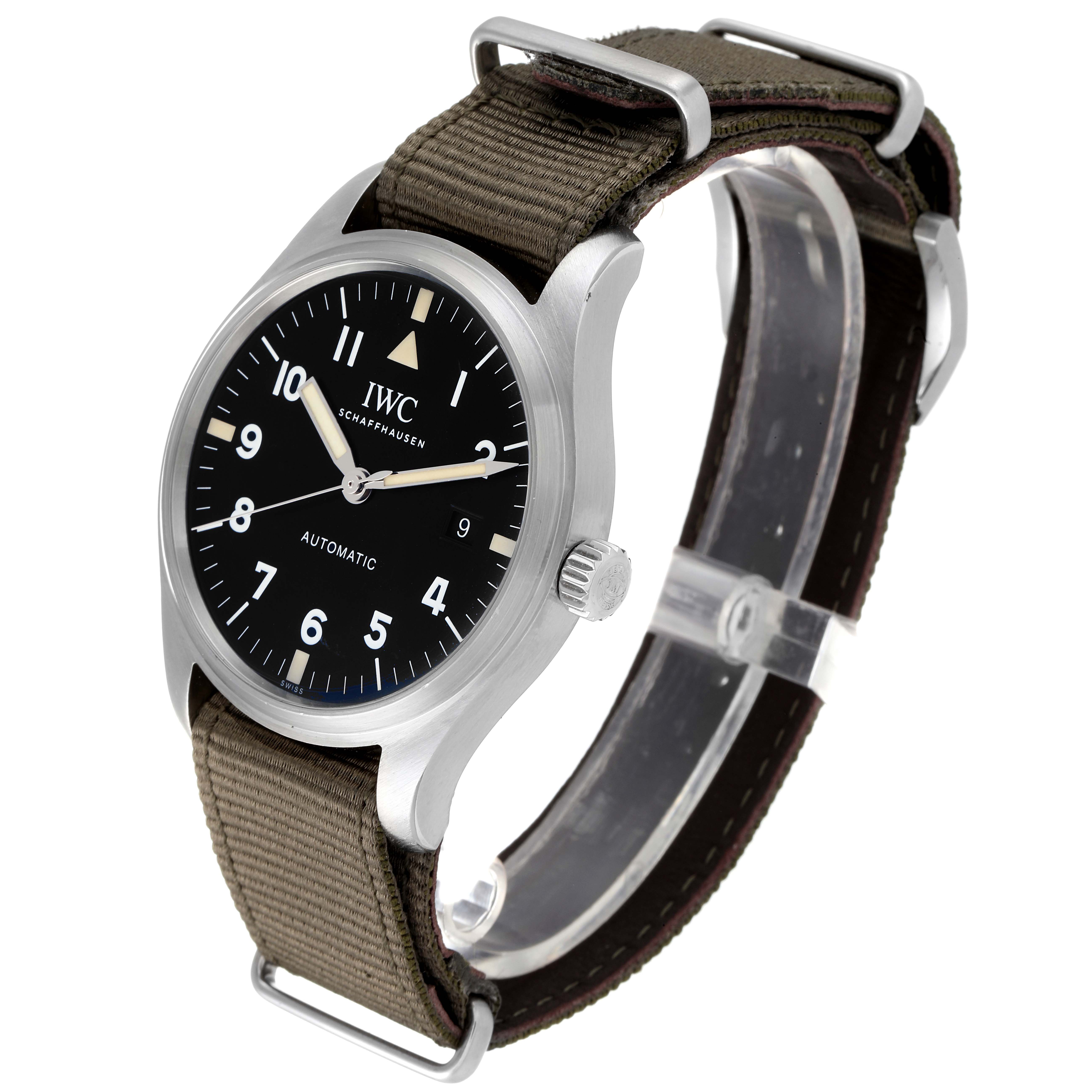 The image shows a side-angle view of an IWC Pilot IW327007 Men's Stainless Steel Black Dial IW327007 Men's Stainless Steel Black Dial model watch, highlighting its face, bezel, crown, and fabric strap.