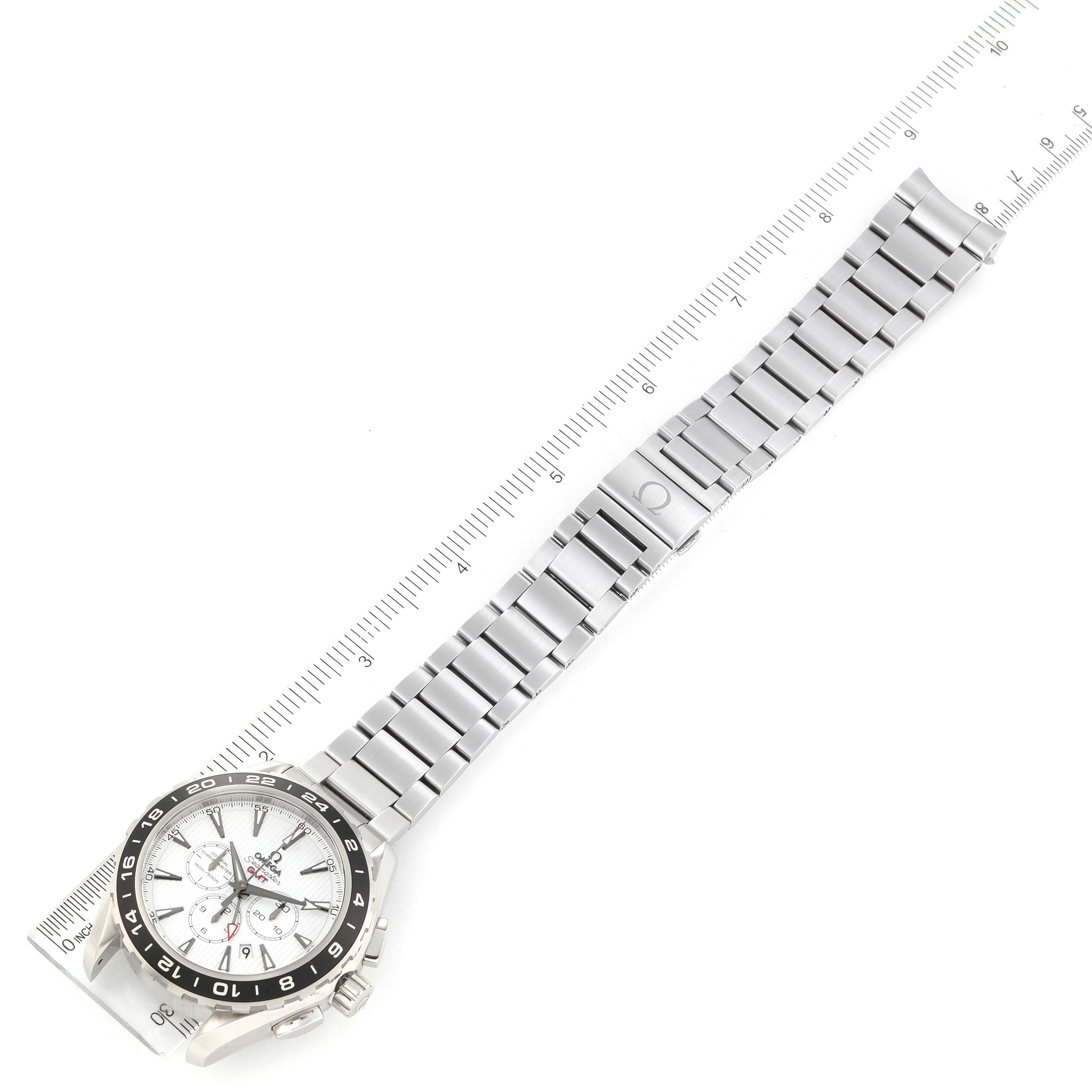 The image shows an overhead view of an Omega Seamaster 231.10.44.52.04.001 Men's Stainless Steel White Dial 231.10.44.52.04.001 Men's Stainless Steel White Dial watch with a silver metal bracelet and a white dial next to a ruler for scale.