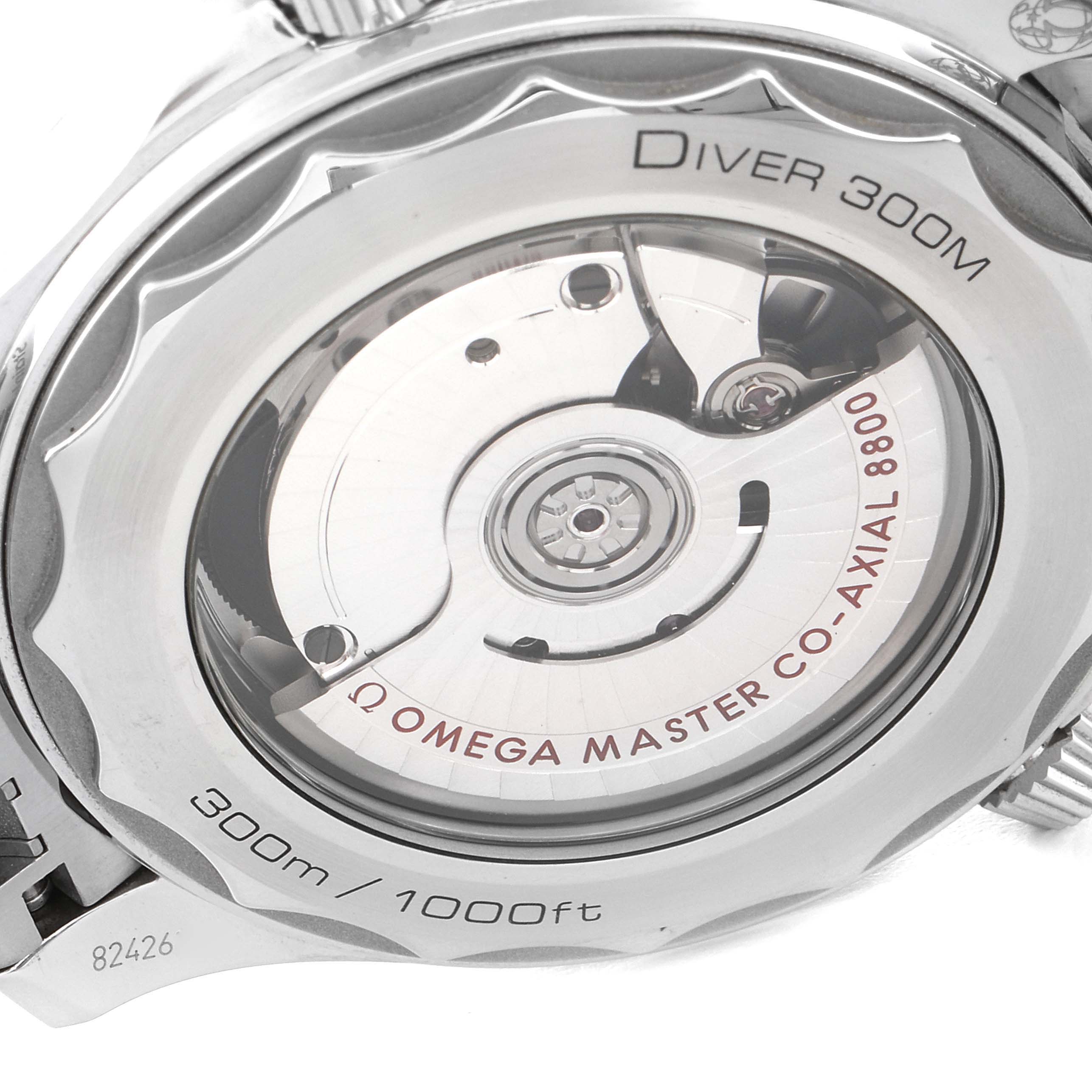 The image shows the transparent case back of an Omega Seamaster 210.30.42.20.03.001 Men's Stainless Steel Blue Dial 210.30.42.20.03.001 Men's Stainless Steel Blue Dial Diver 300M, focusing on the Co-Axial Master Chronometer movement.