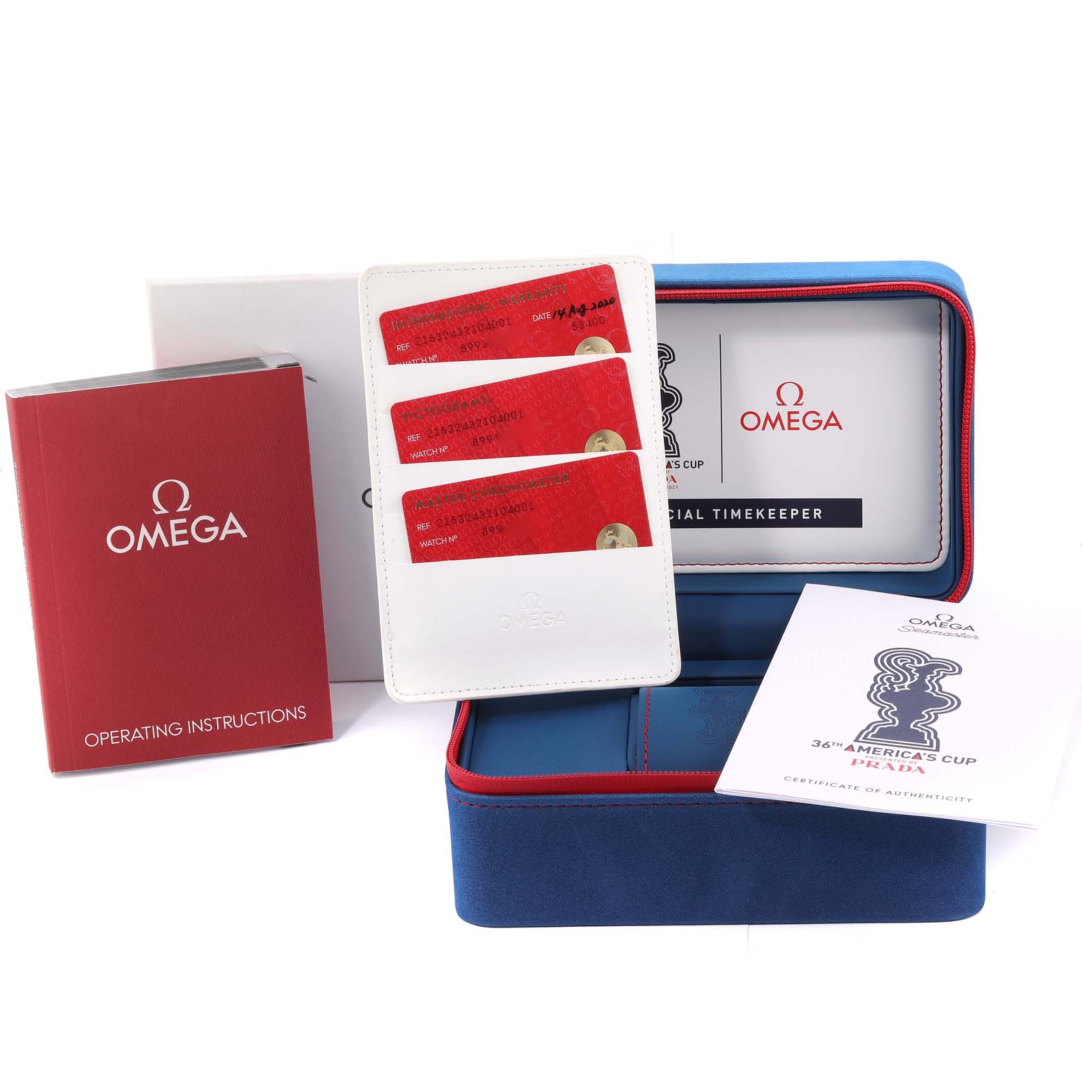 The image shows accessories for an Omega Planet Ocean 215.32.43.21.04.001 Men's Stainless Steel White Dial 215.32.43.21.04.001 Men's Stainless Steel White Dial watch, including a box, warranty cards, and operating instructions.