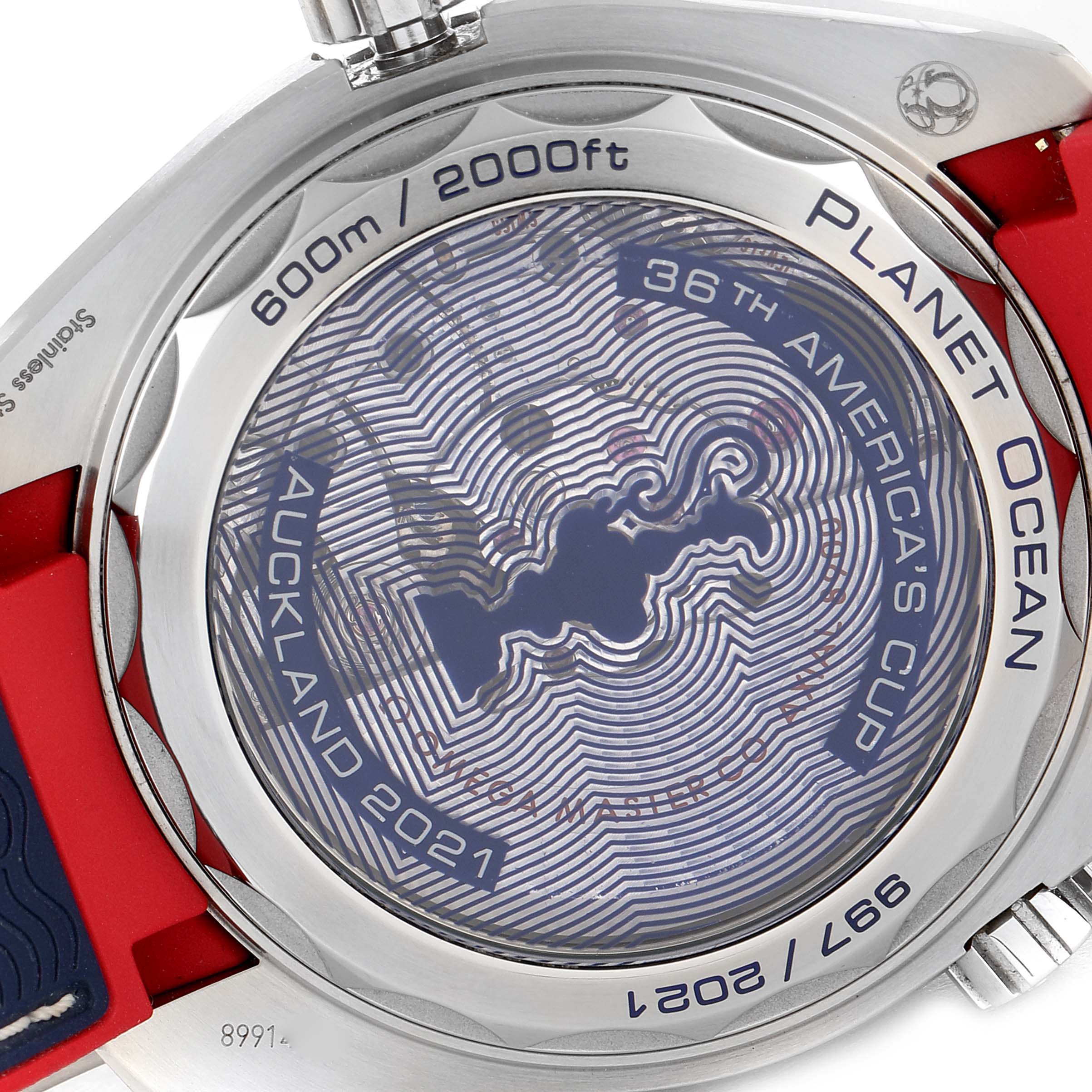 The image shows the case back of the Omega Planet Ocean 215.32.43.21.04.001 Men's Stainless Steel White Dial 215.32.43.21.04.001 Men's Stainless Steel White Dial watch, featuring an engraving commemorating Auckland 2021 and the 36th America's Cup.