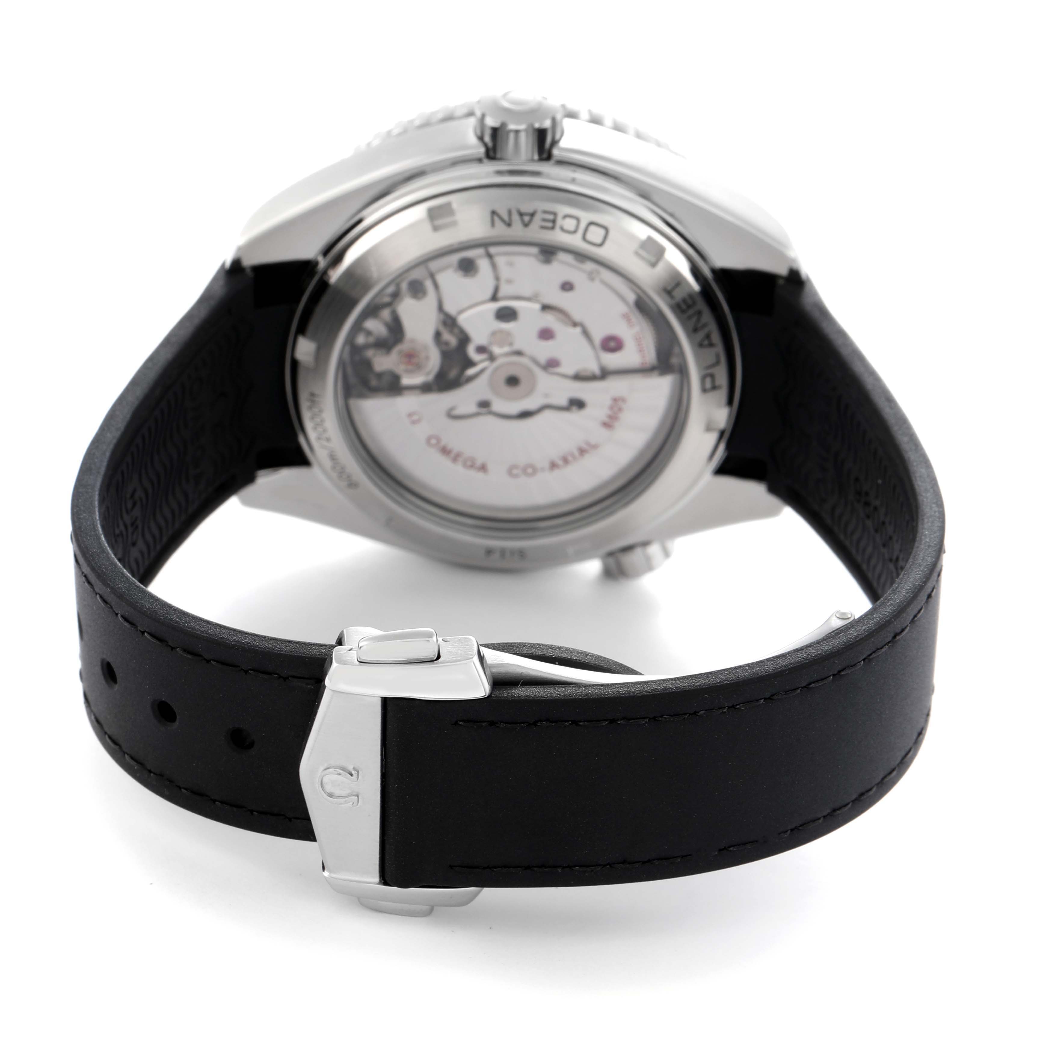 The image shows the back of the Omega Planet Ocean 232.32.44.22.01.001 Men
s Stainless Steel Black Dial 232.32.44.22.01.001 Men
s Stainless Steel Black Dial watch with its open case back and a black strap with a clasp.