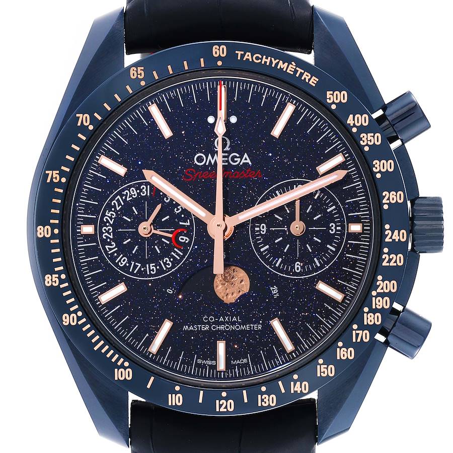 The Omega Speedmaster watch is shown from the front, highlighting its face, tachymeter bezel, and chronograph subdials.