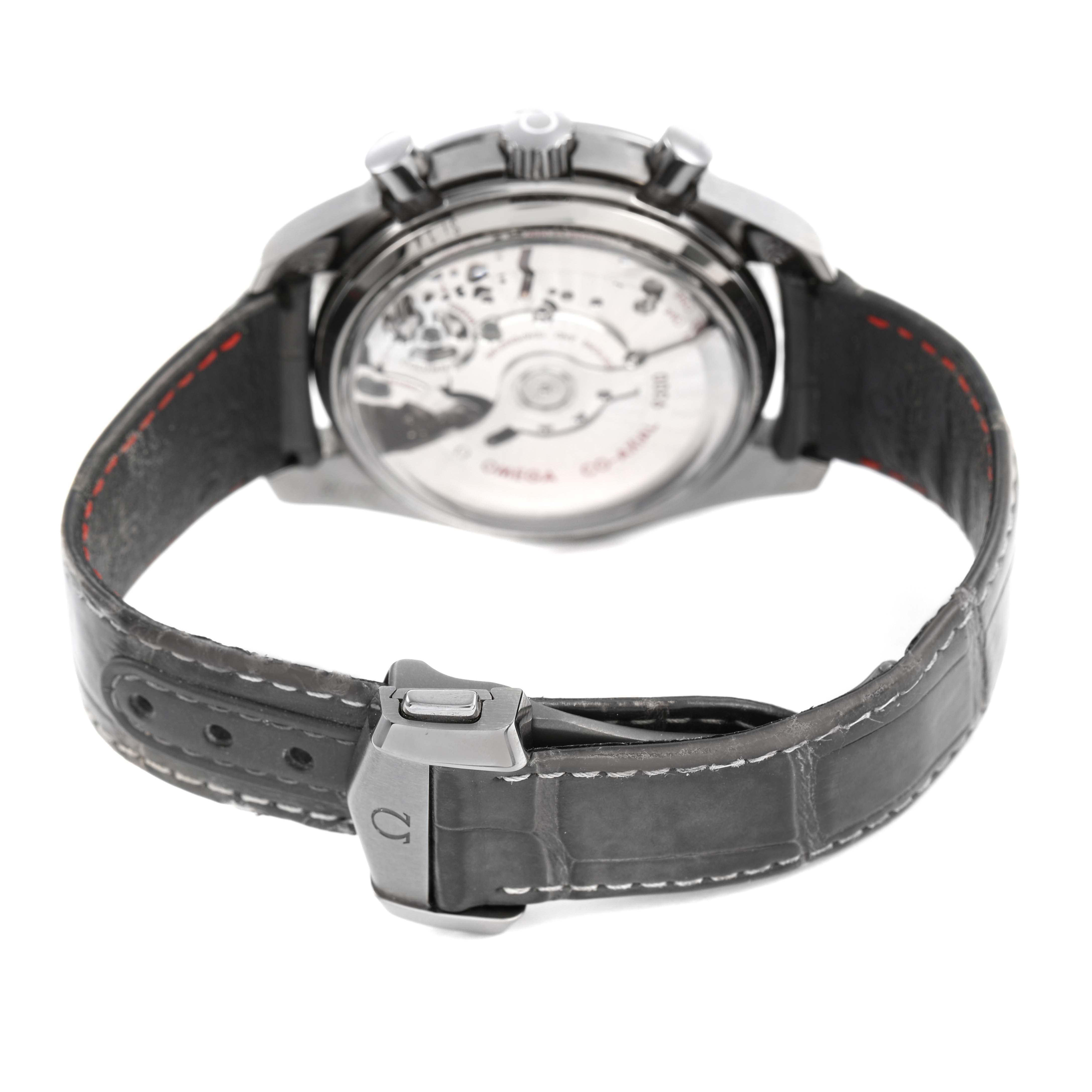 The Omega Speedmaster 311.93.44.51.99.002 Men's Ceramic Grey Dial watch is shown from the back, highlighting the transparent case back and leather strap.