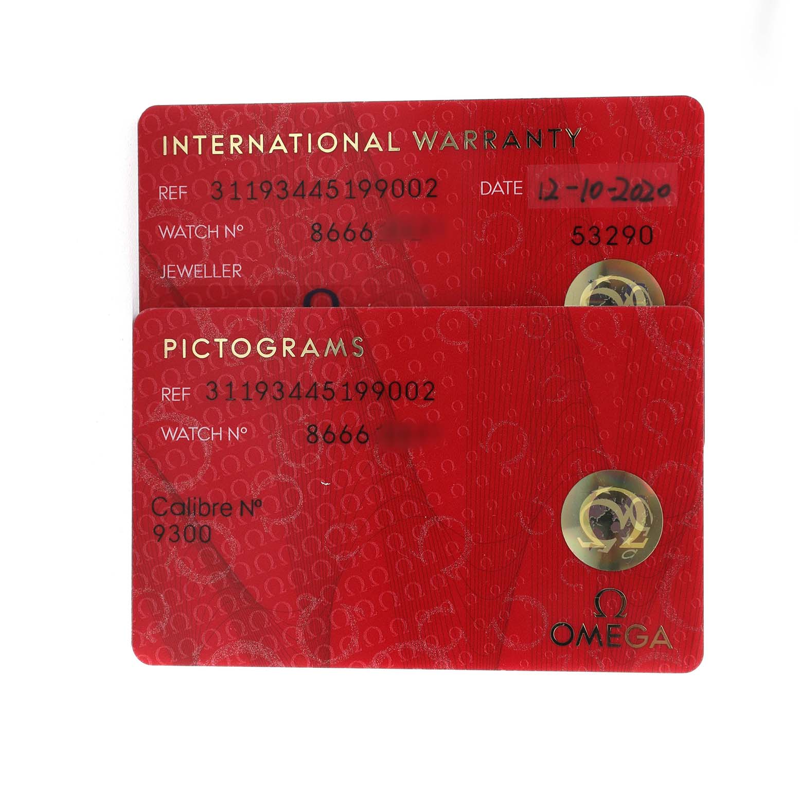 The image shows warranty and pictogram cards for the Omega Speedmaster 311.93.44.51.99.002 Men's Ceramic Grey Dial, viewed from above.