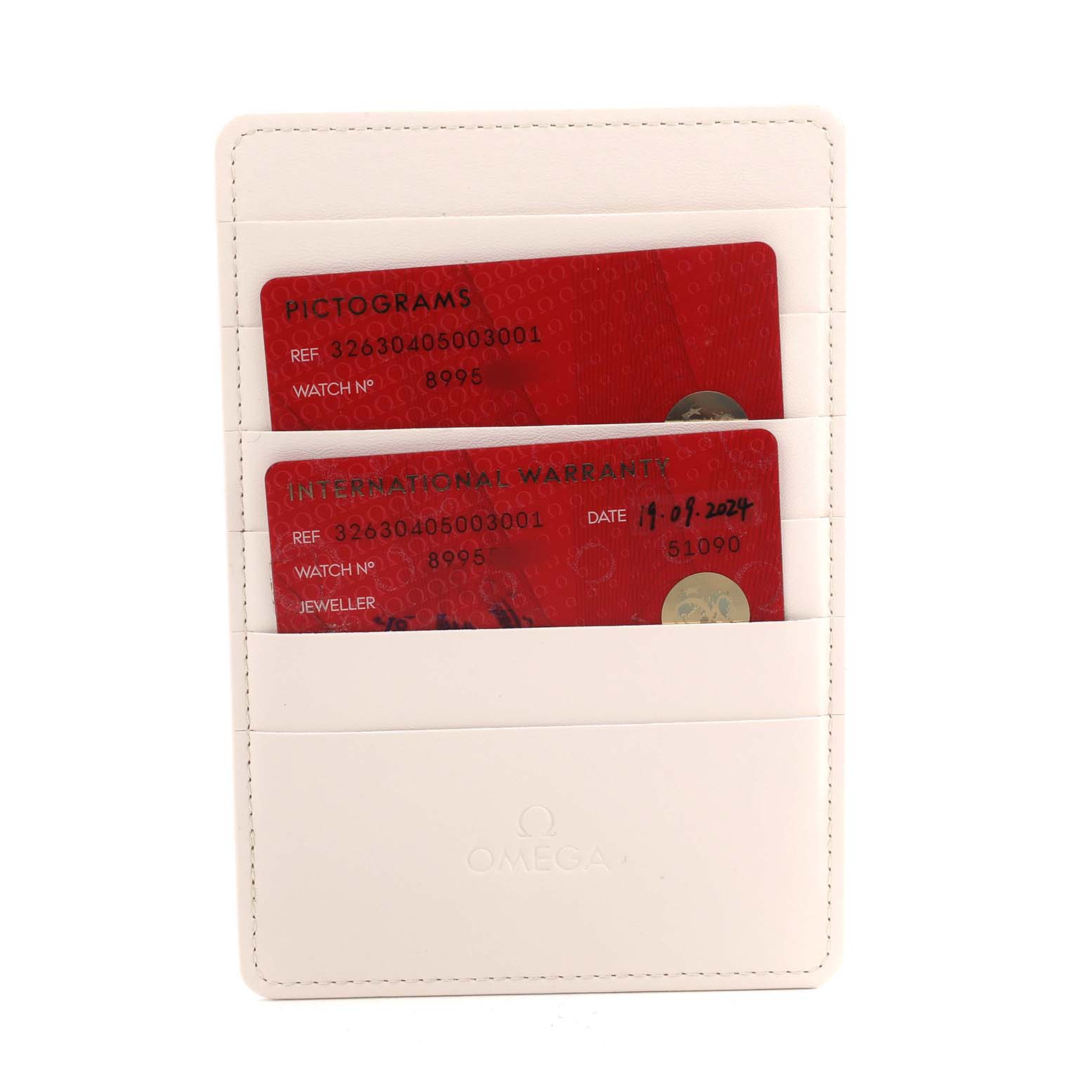 The image shows a white Omega cardholder with warranty and pictogram cards for the Omega Speedmaster 326.30.40.50.03.001 Men's Stainless Steel Blue Dial.