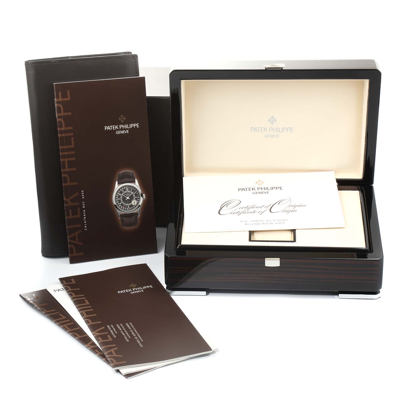 The image shows the packaging, booklet, and certificate for the Patek Philippe Calatrava 6000R Men's Rose Gold Brown Dial 6000R Men's Rose Gold Brown Dial watch, with the box open and documents displayed.