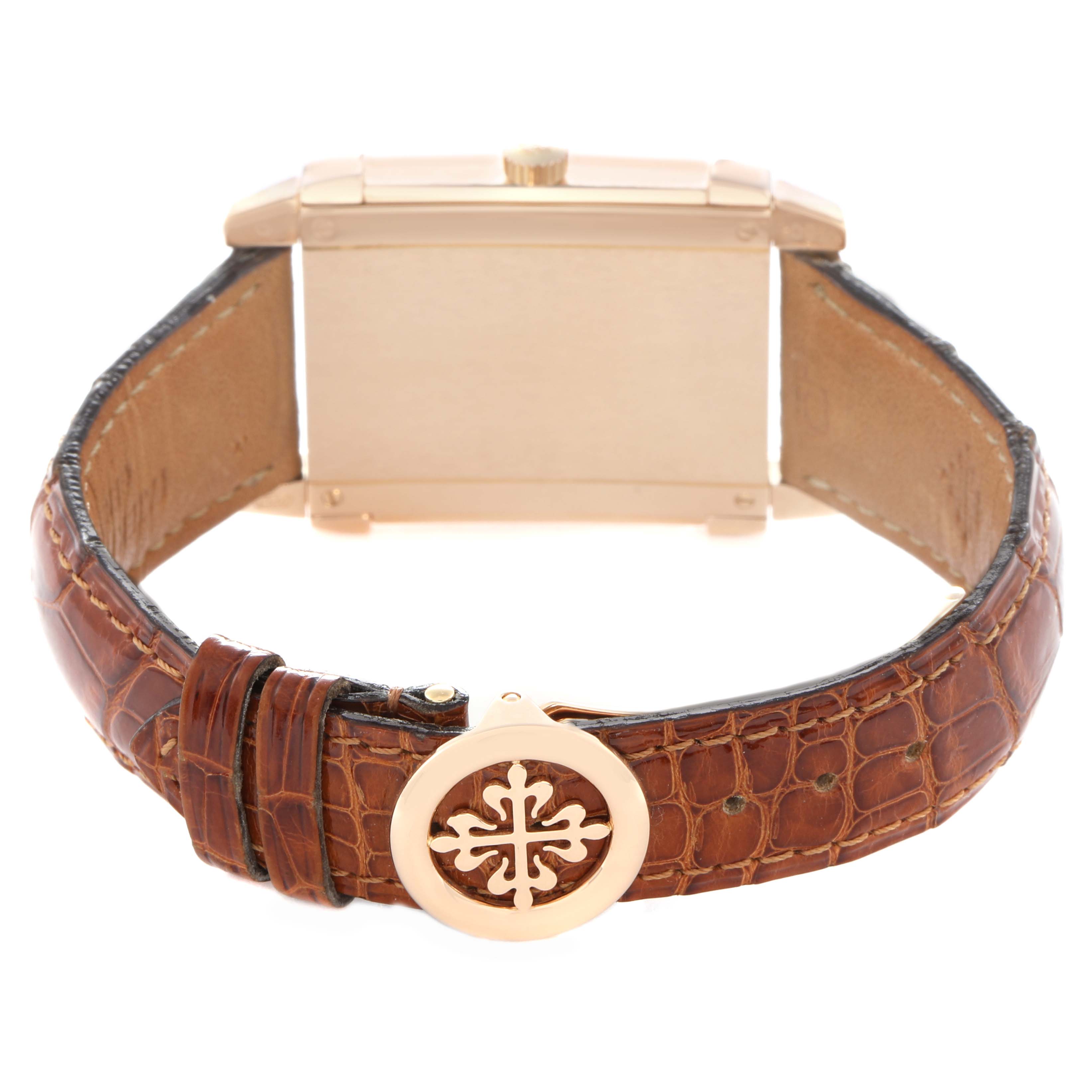 The image shows the back of a Patek Philippe Gondolo 5111R-001 Men's Rose Gold Silver Dial watch with a brown leather strap and a decorative buckle.