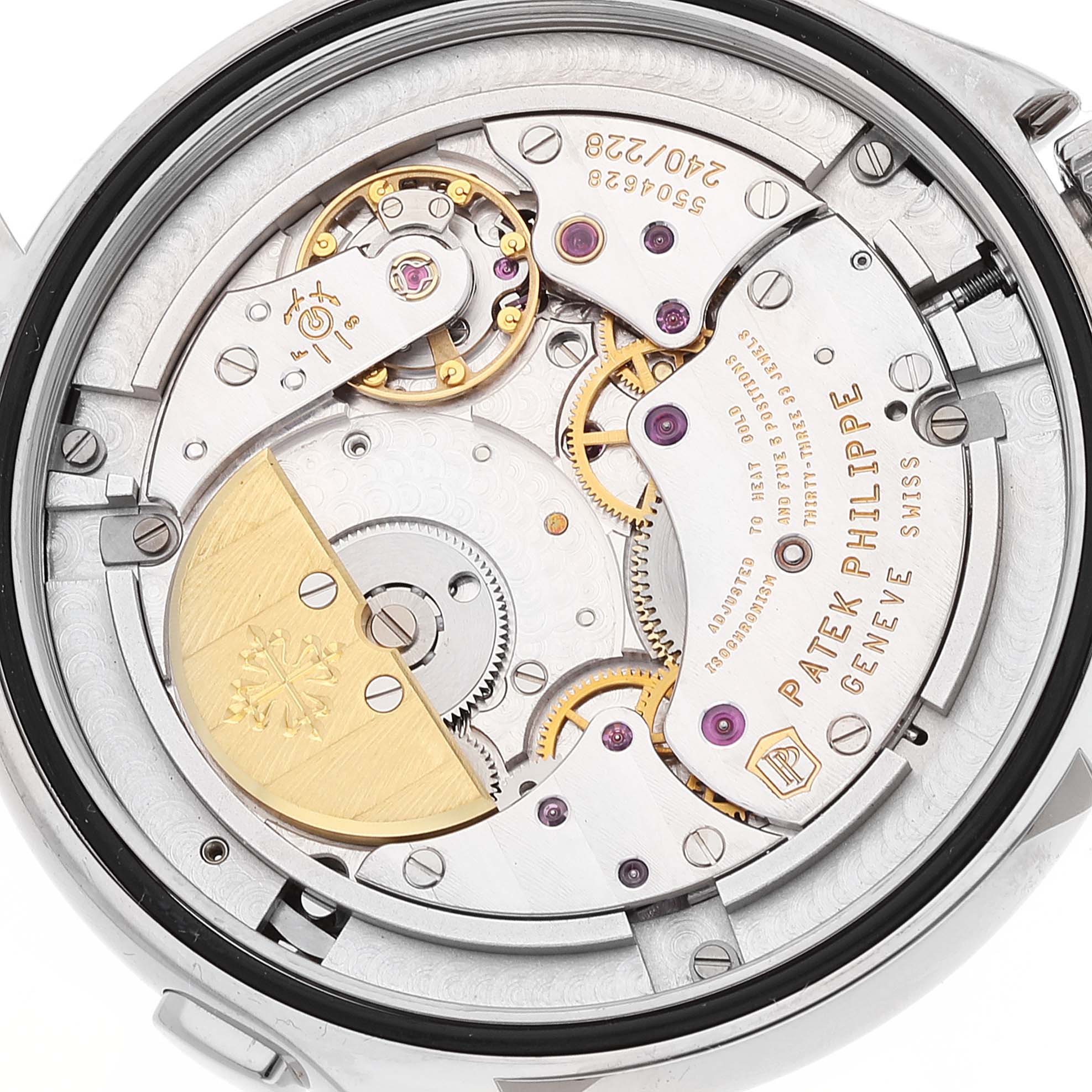The image shows the back of the Patek Philippe Complications 5130G-019 Men's White Gold Silver Dial 5130G-019 Men's White Gold Silver Dial watch, highlighting the intricate mechanics and movement components.