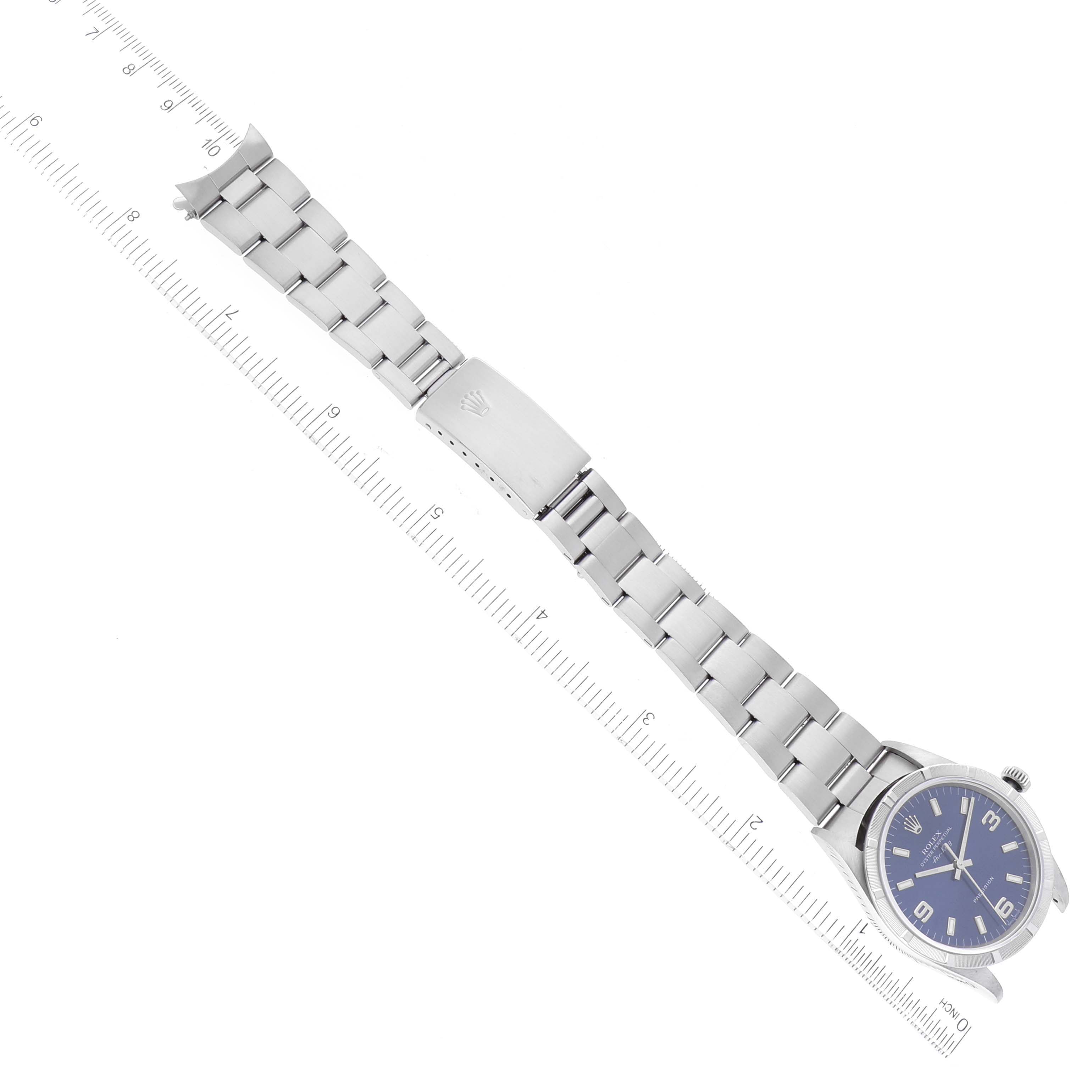The image shows a flat-lay view of the Rolex Air-King 14010 Men's Stainless Steel Blue Dial 14010 Men's Stainless Steel Blue Dial watch, displaying the face, bracelet, and clasp fully extended next to a ruler.