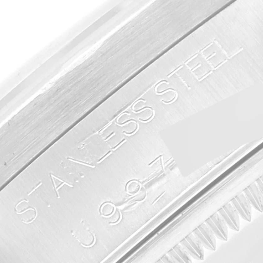 The image shows a close-up of the stainless steel case and engravings of a Rolex Air-King 14010 Men's Stainless Steel Blue Dial 14010 Men's Stainless Steel Blue Dial watch model.