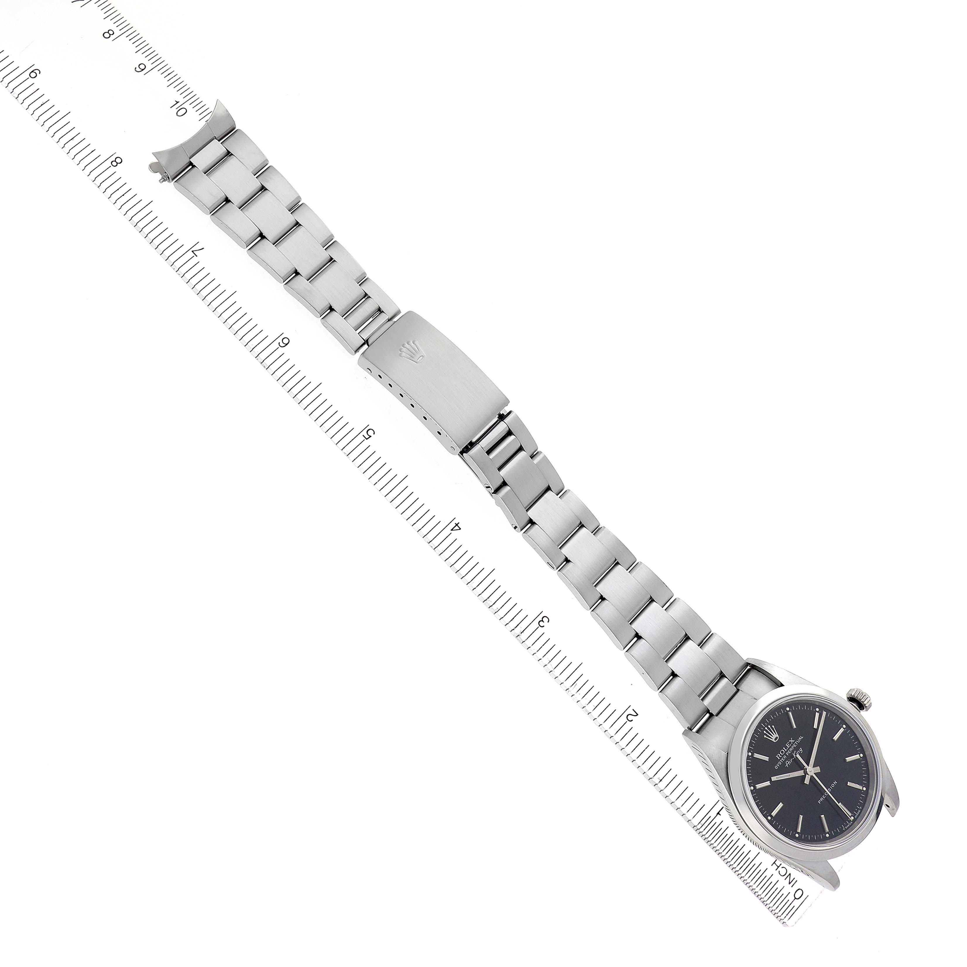 The Rolex Air-King 14000 Men
s Stainless Steel Black Dial 14000 Men
s Stainless Steel Black Dial watch is shown at a slight angle, displaying the full band, clasp, and face alongside a ruler for scale.