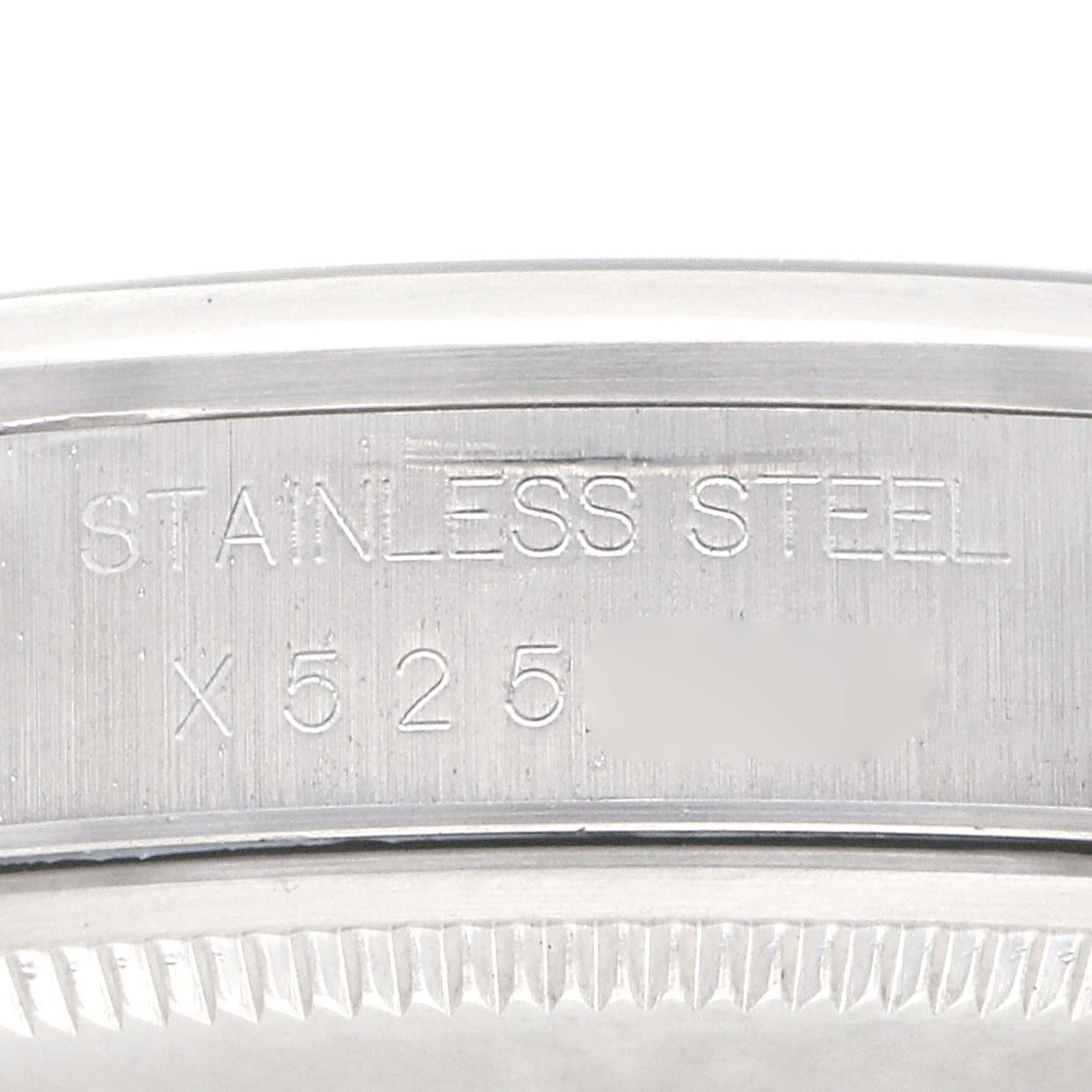 The image shows a close-up of the case back of a Rolex Air-King 14000 Men
s Stainless Steel Blue Dial 14000 Men
s Stainless Steel Blue Dial with "STAINLESS STEEL" engraved.